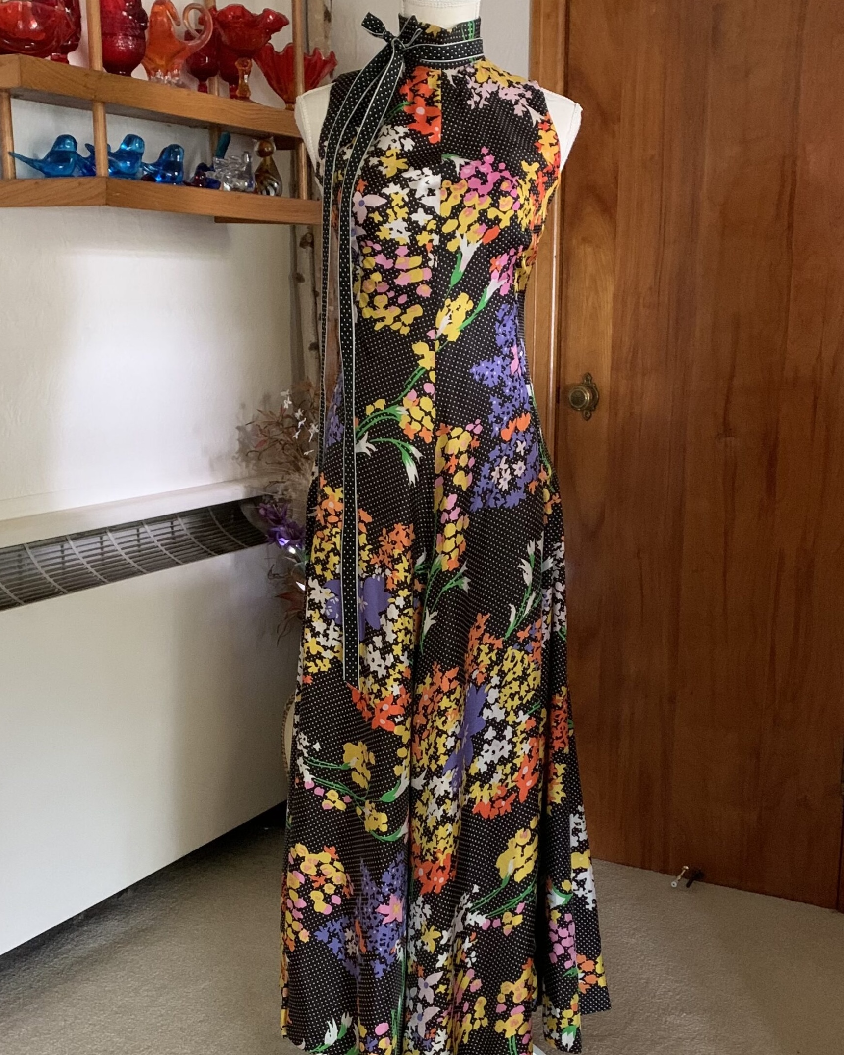 Geoffrey Beene Boutique 1970s floral halter maxi dress with black polka dot ground and vivid orange, yellow, pink, and lavender floral print