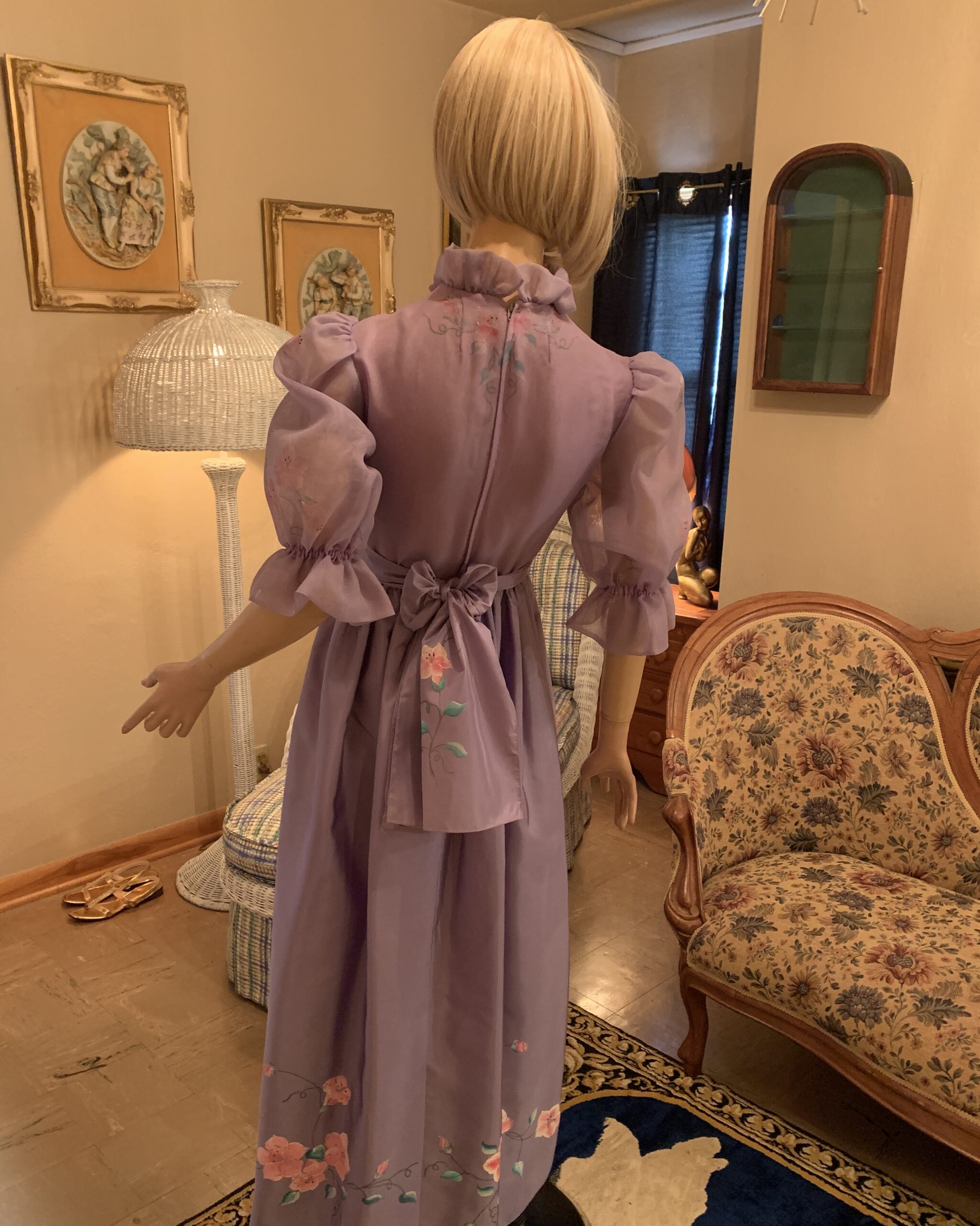 Back view of a vintage Elizabeth Arden lavender maxi dress showing the self-tie sash, back zipper, and hand-painted floral accents.