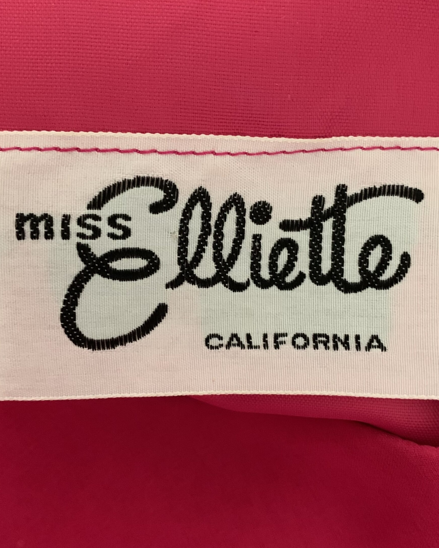 Miss Elliette California woven label sewn into hot pink cocktail dress