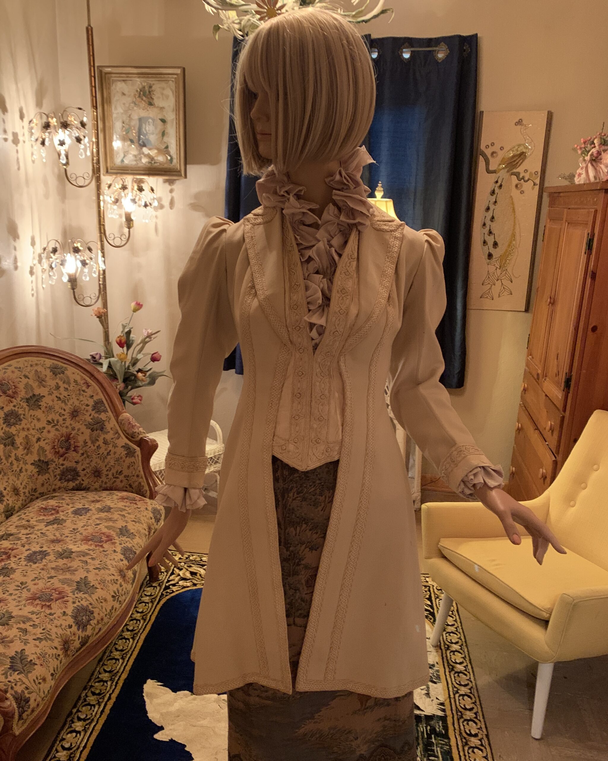 Late Victorian ivory wool walking coat with soutache trim, puffed sleeves, and fitted silhouette displayed on a mannequin.