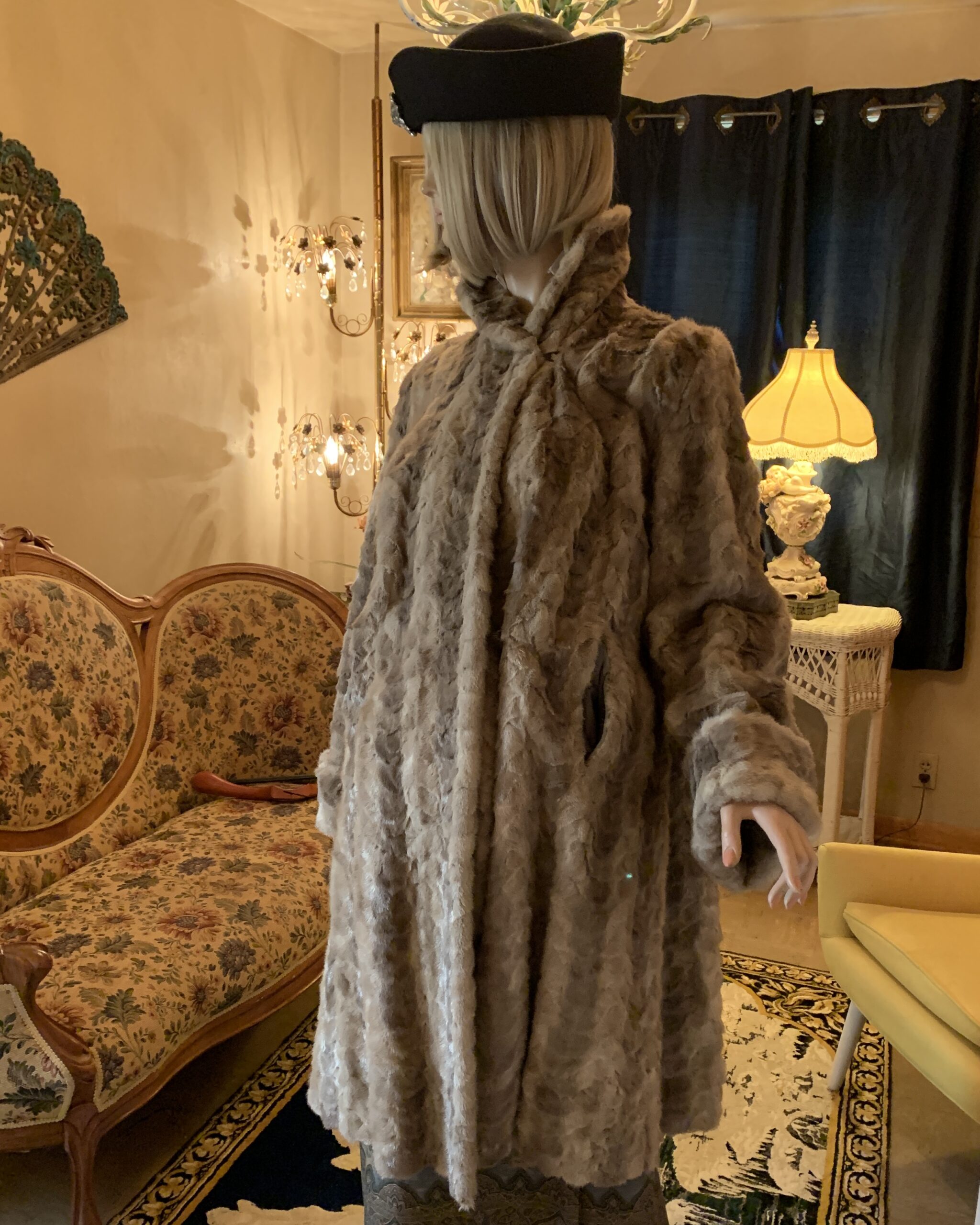 Angled front view of a vintage faux fur coat highlighting the high collar, textured fur, and relaxed silhouette.