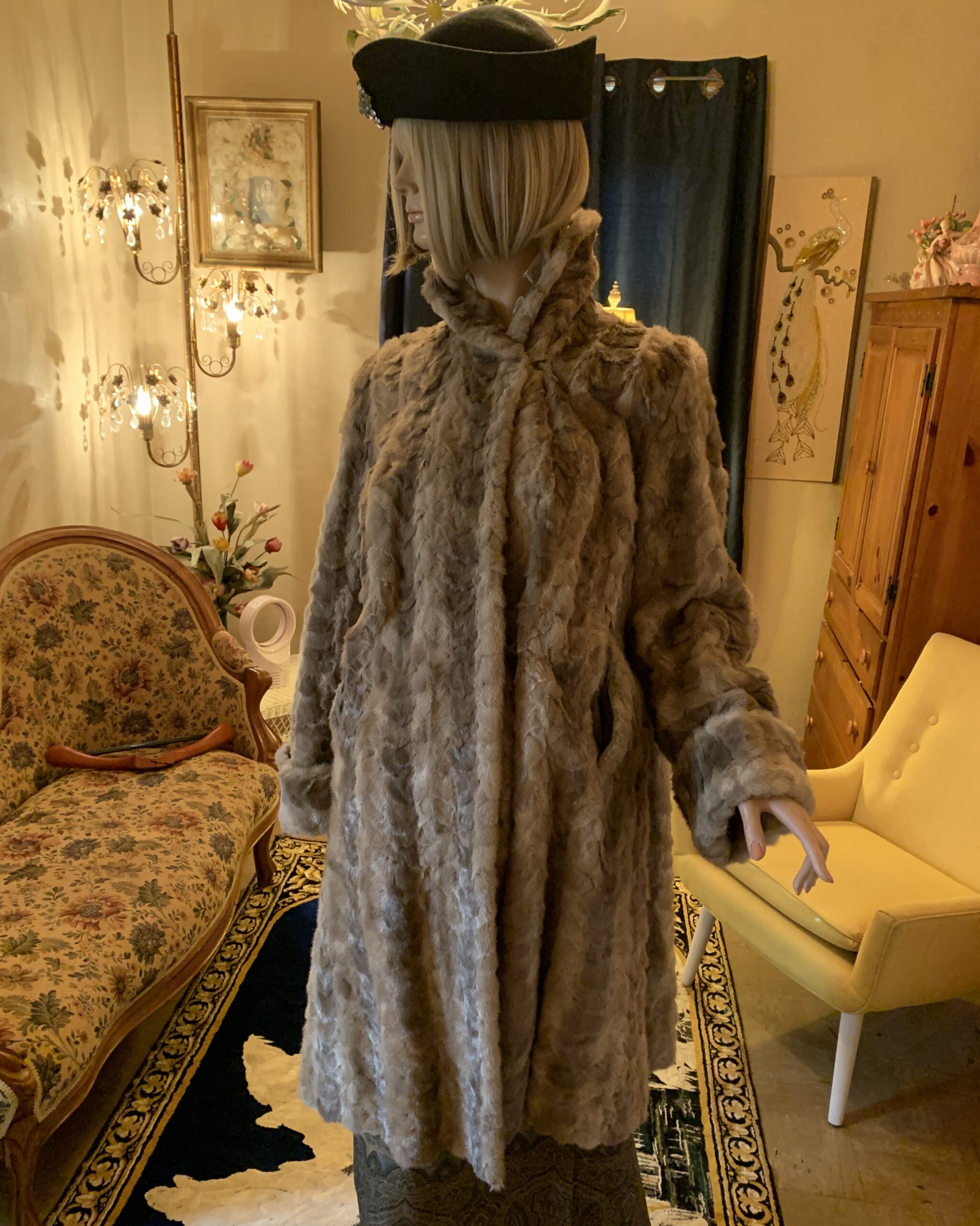 Vintage faux fur coat with a high stand collar and textured fur shown on a mannequin in a salon setting.