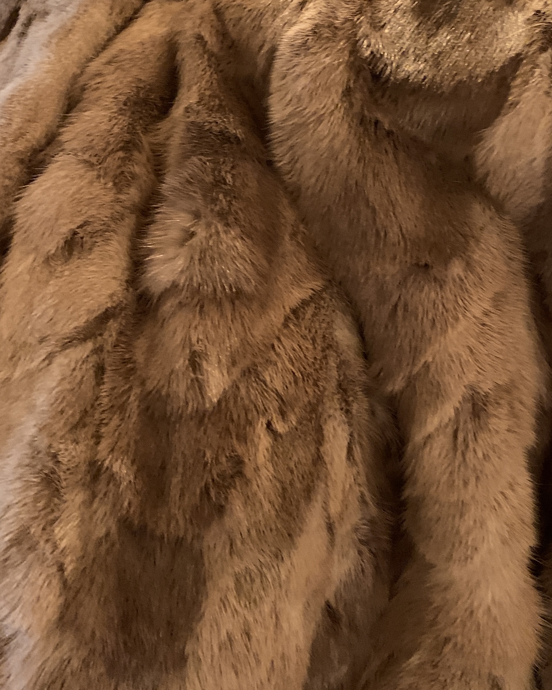 Close-up of the textured faux fur showing the soft striped pattern and plush pile on a vintage coat.