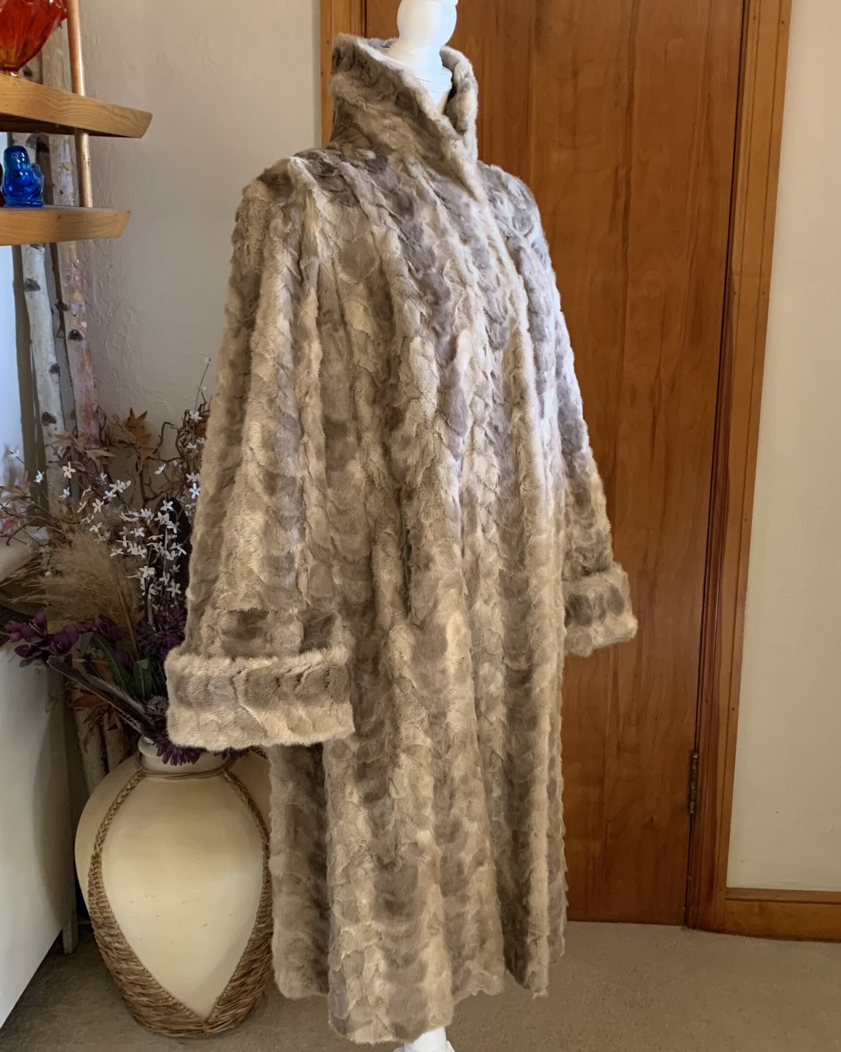 Vintage taupe mink coat with stand collar shown at an angle on mannequin.