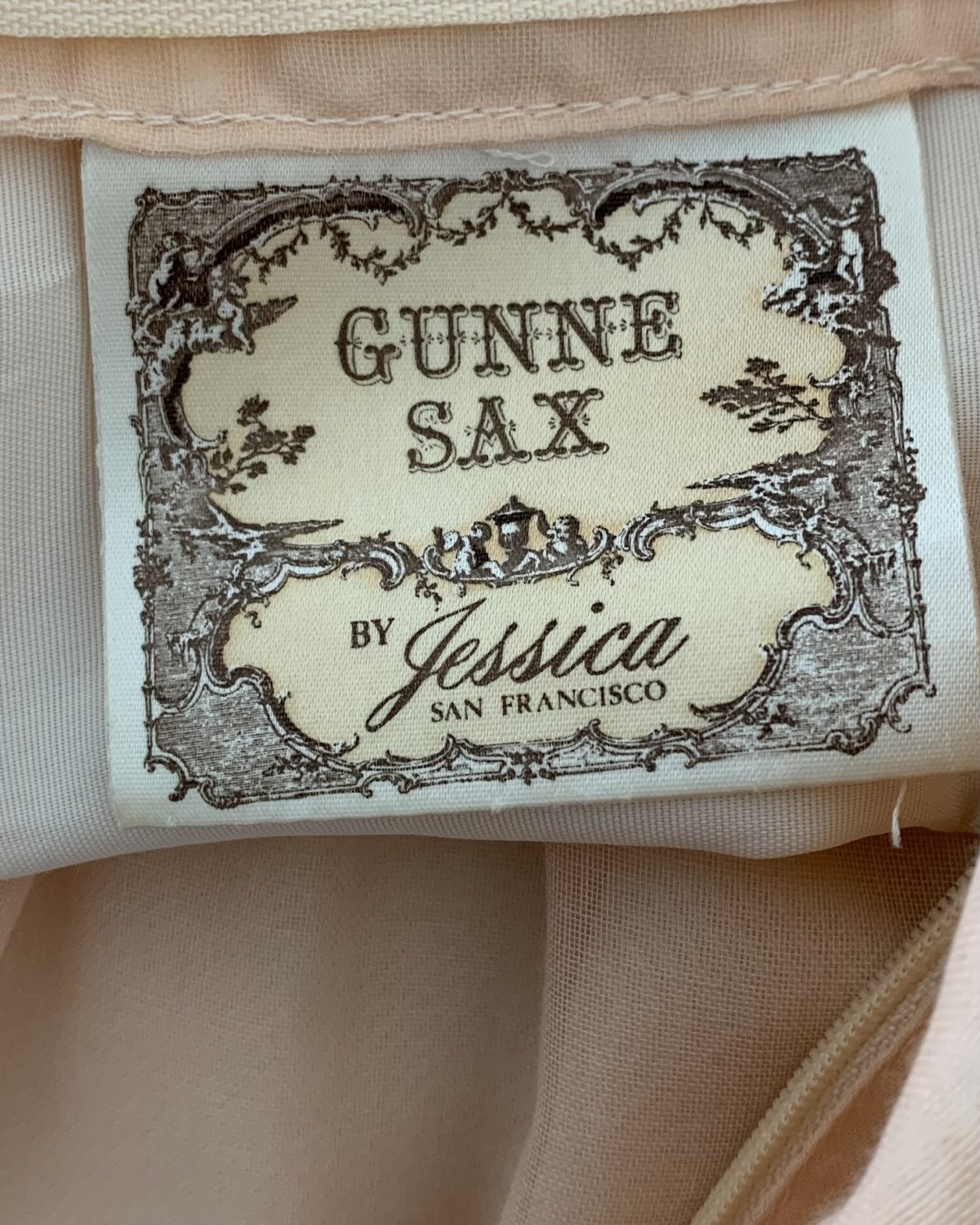 Close-up of the original Gunne Sax by Jessica San Francisco label inside a vintage peach prairie dress.