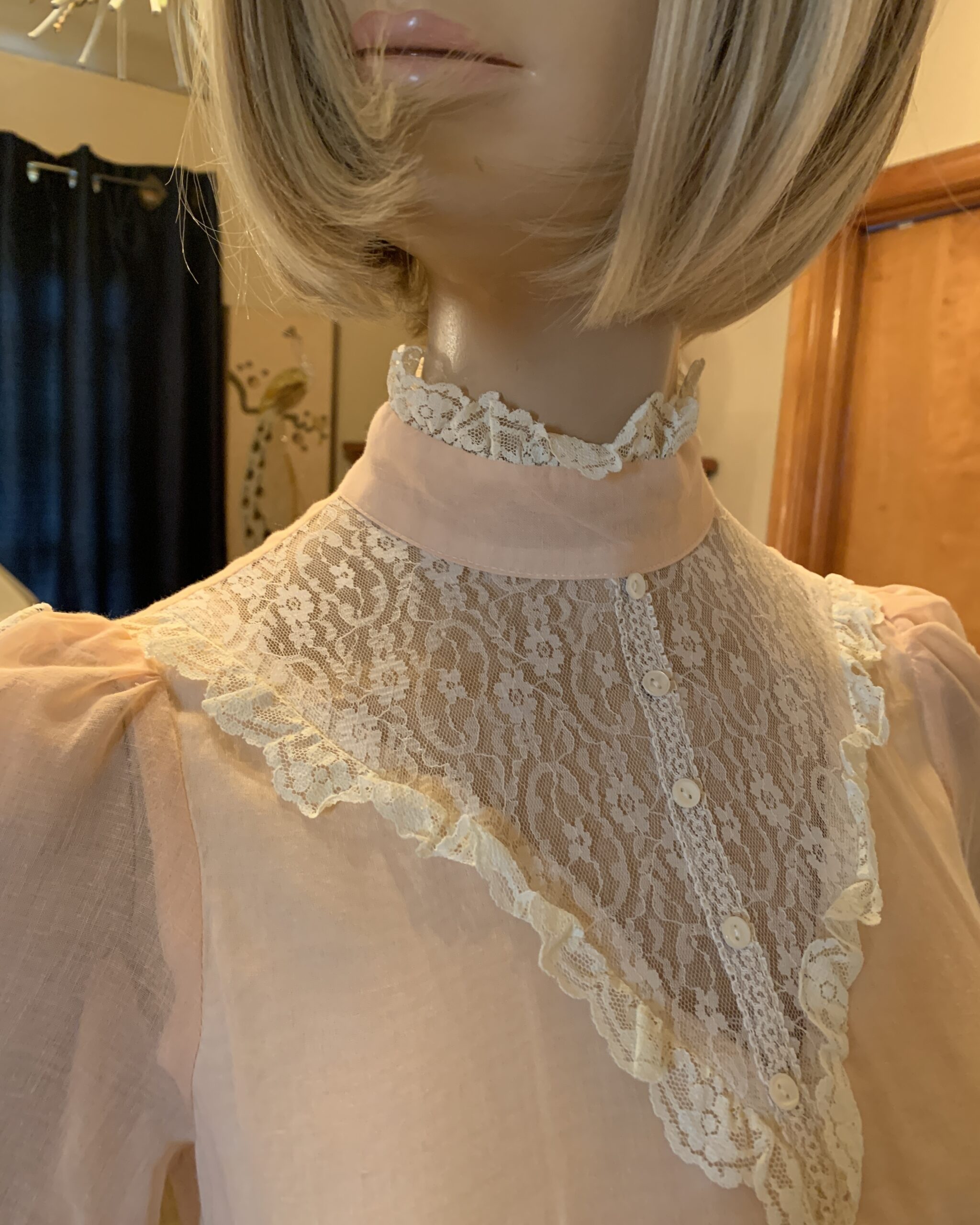 Close-up of the lace bib neckline and high collar detail on a vintage Gunne Sax peach prairie dress.