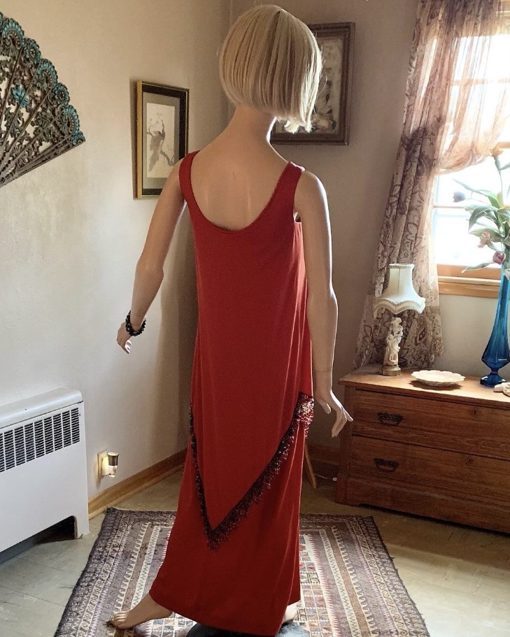 Back view of vintage Jack Bryan by Dupuis red hostess gown with long streamlined silhouette and sleeveless design.