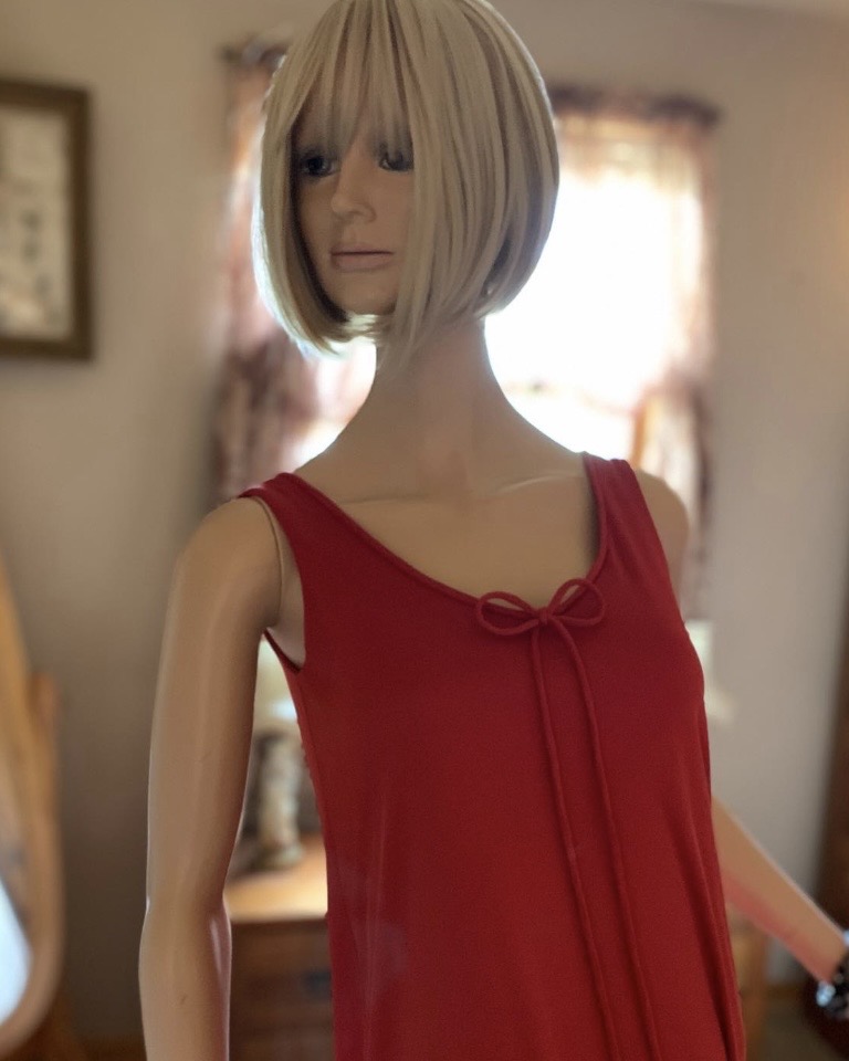 Close front view of vintage red Jack Bryan by Dupuis cocktail gown featuring draped neckline bow and layered beaded front panel.