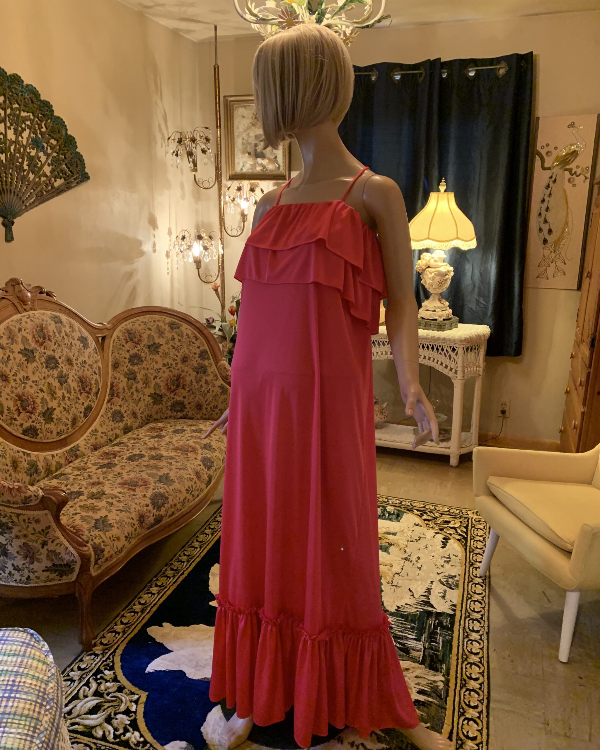 Three-quarter view of a vintage Lucie Ann watermelon pink maxi dress with layered ruffle bodice and flowing full-length skirt.