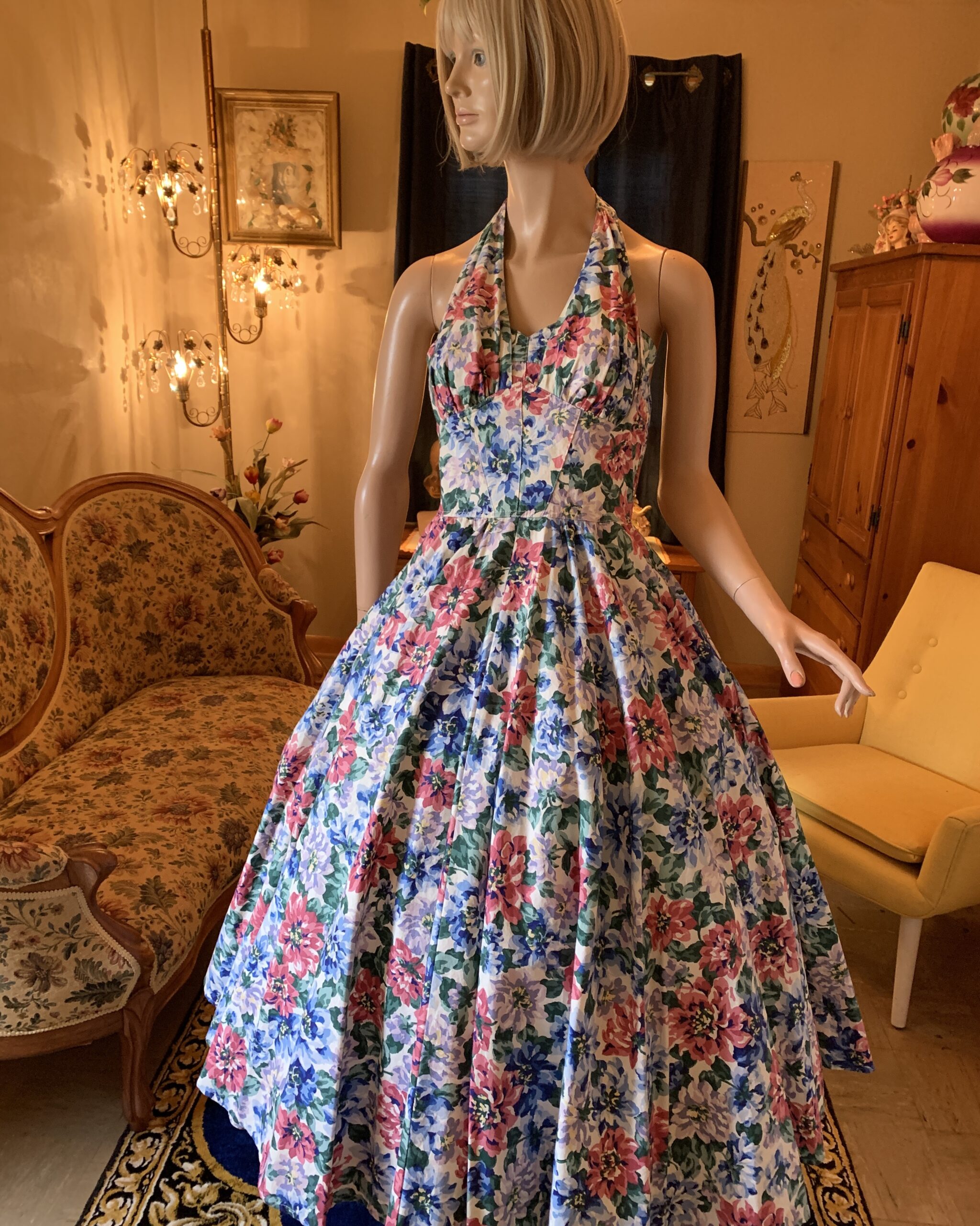 1980s Karen Alexander floral halter dress with full skirt and pink, blue, and lavender garden floral print.
