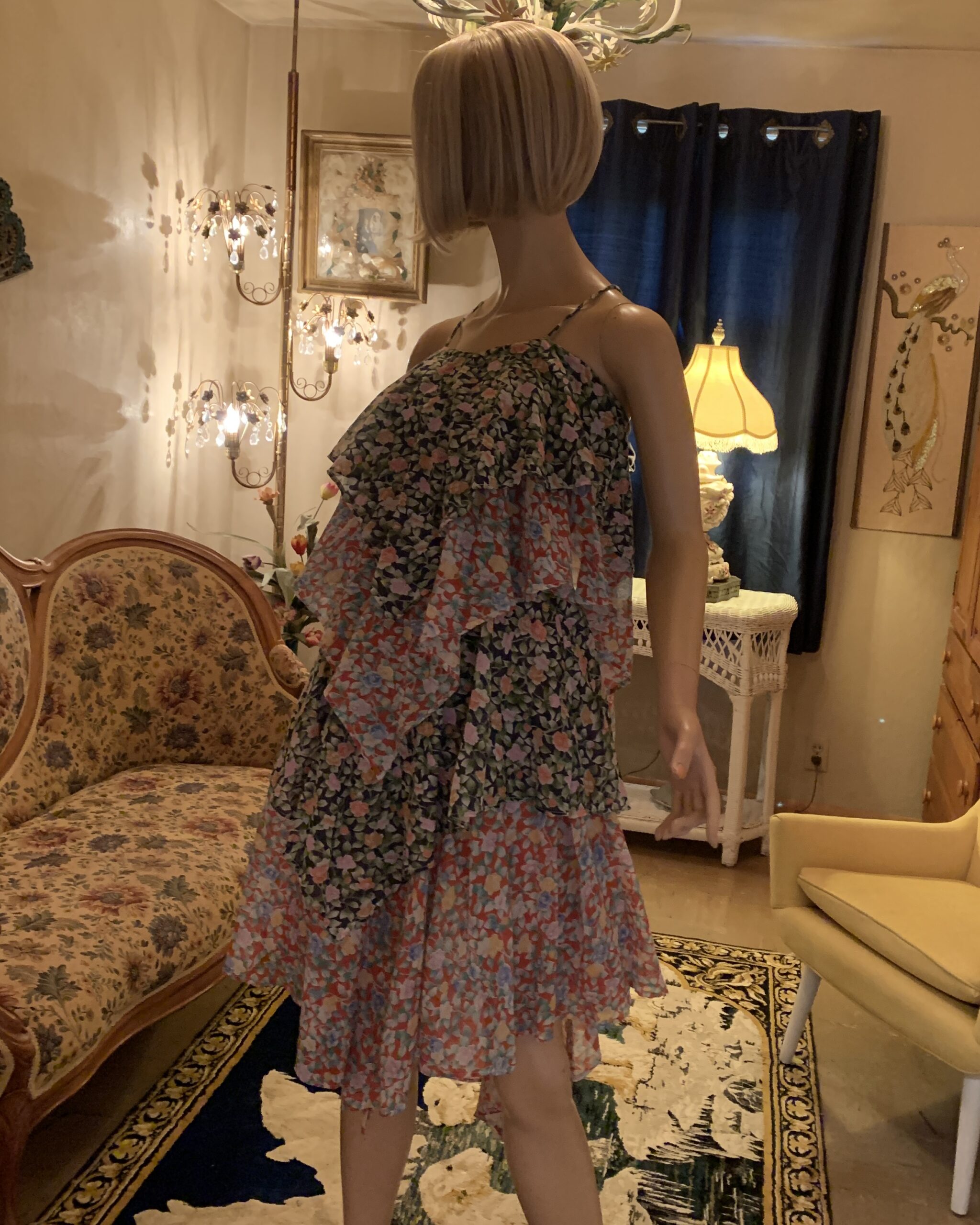 Vintage tiered floral chiffon dress with layered ruffle overlay and spaghetti straps displayed on a mannequin.