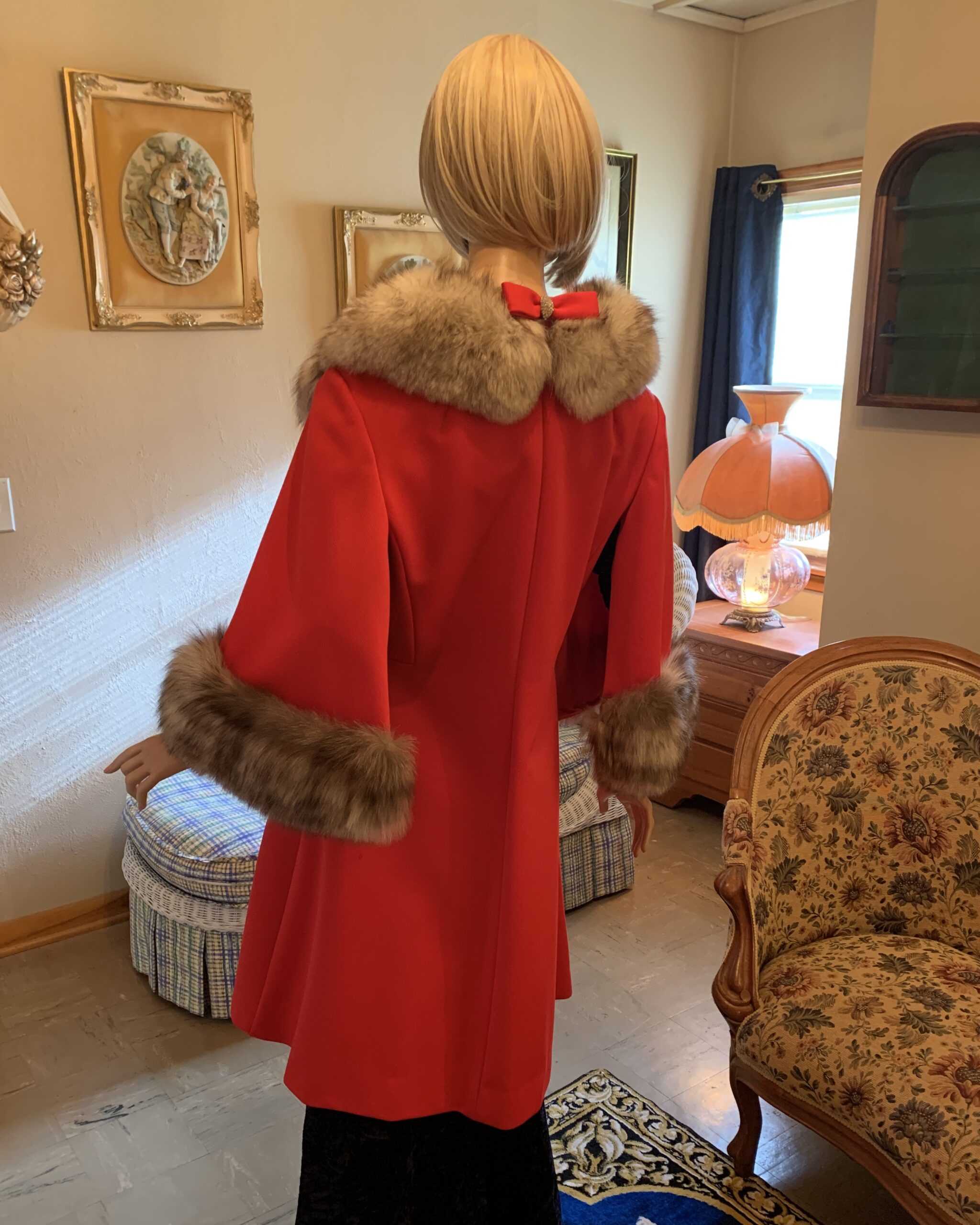 Back view of a vintage Lilli Ann wool coat with fox fur collar, featuring a decorative bow detail at the back neckline.