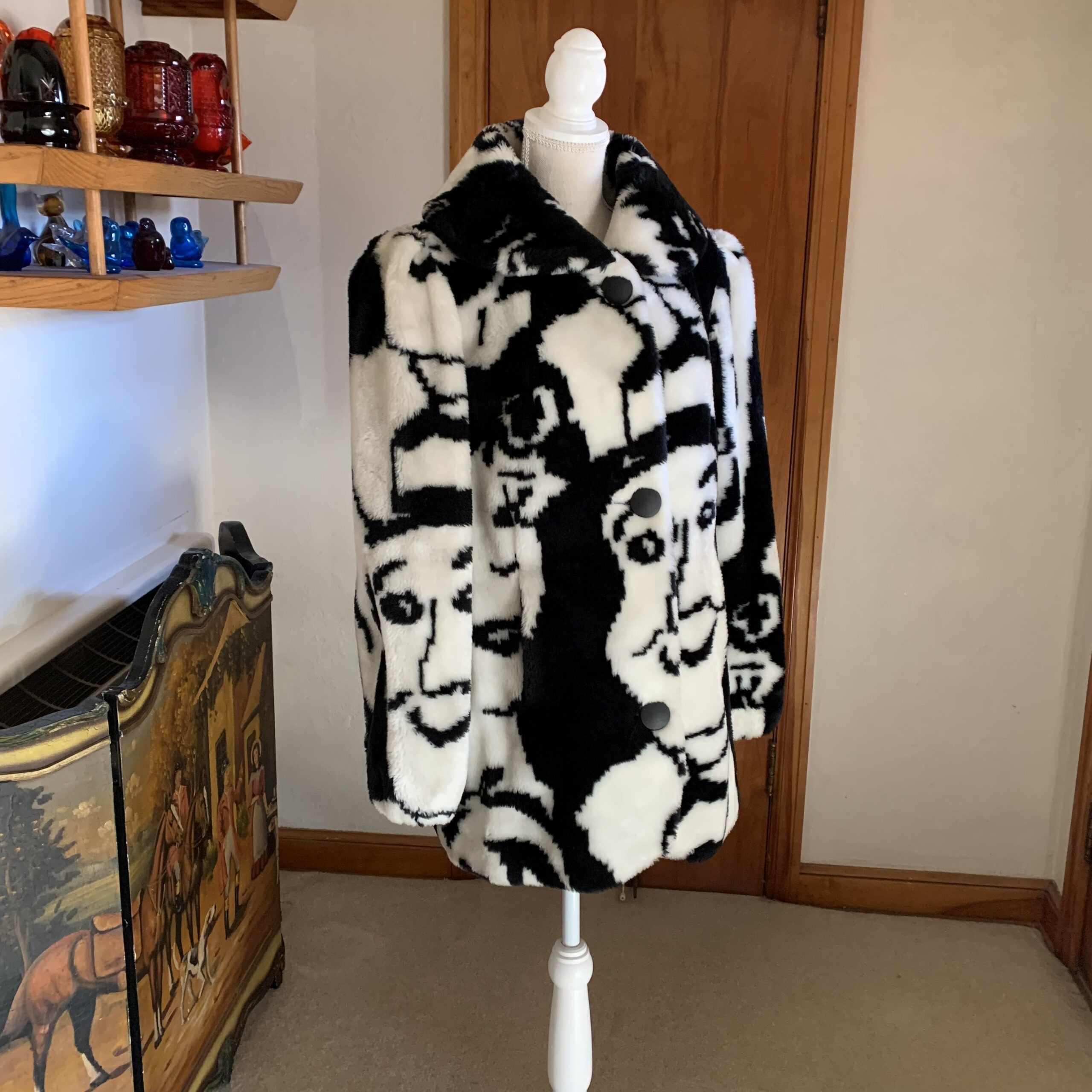 Bold vintage 1980s pop-art faux fur coat featuring an allover black-and-white illustrated faces design. Soft, plush, fully lined, and exceptionally rare — a true wearable art statement piece.