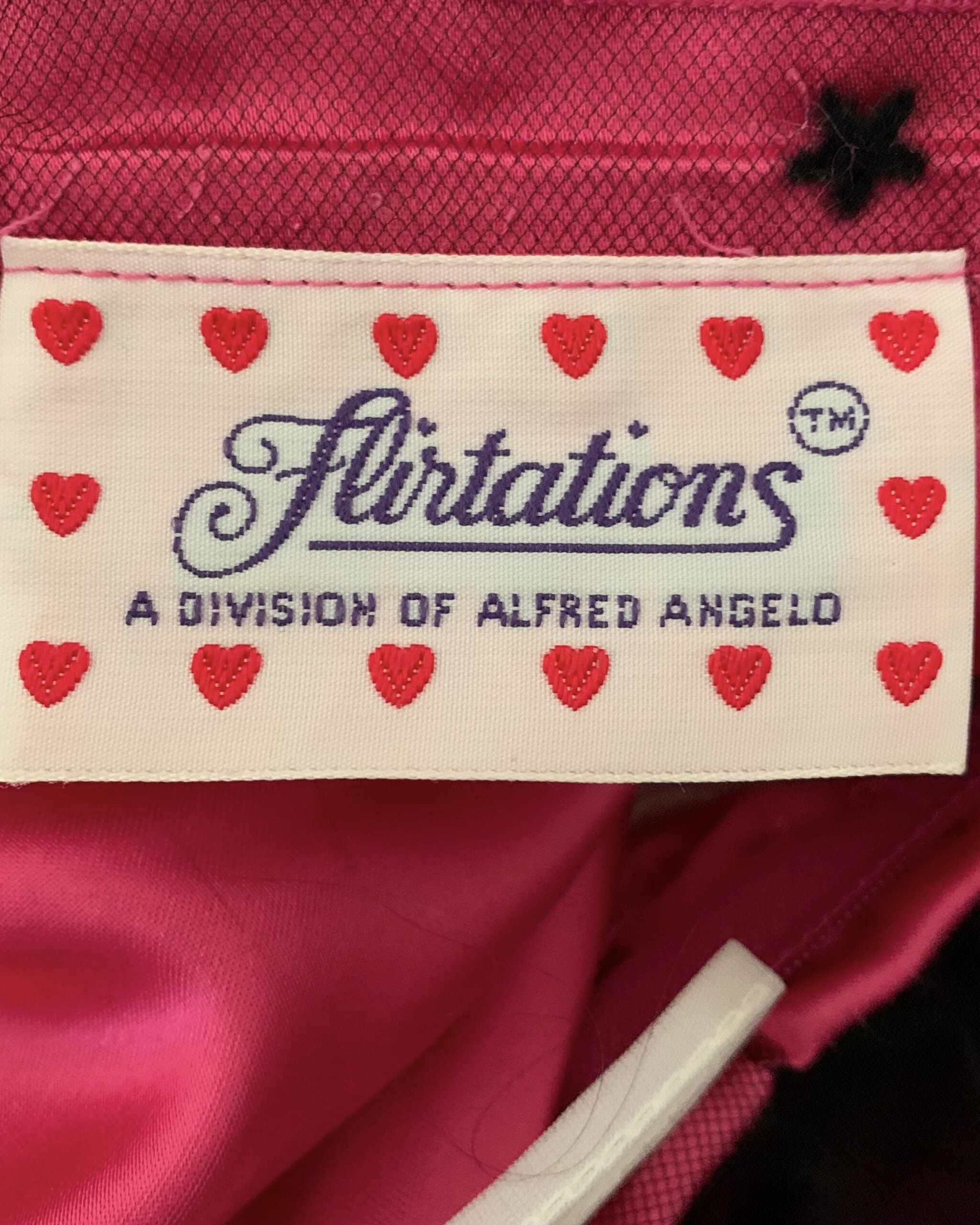 Flirtations label with red hearts reading “A Division of Alfred Angelo.”