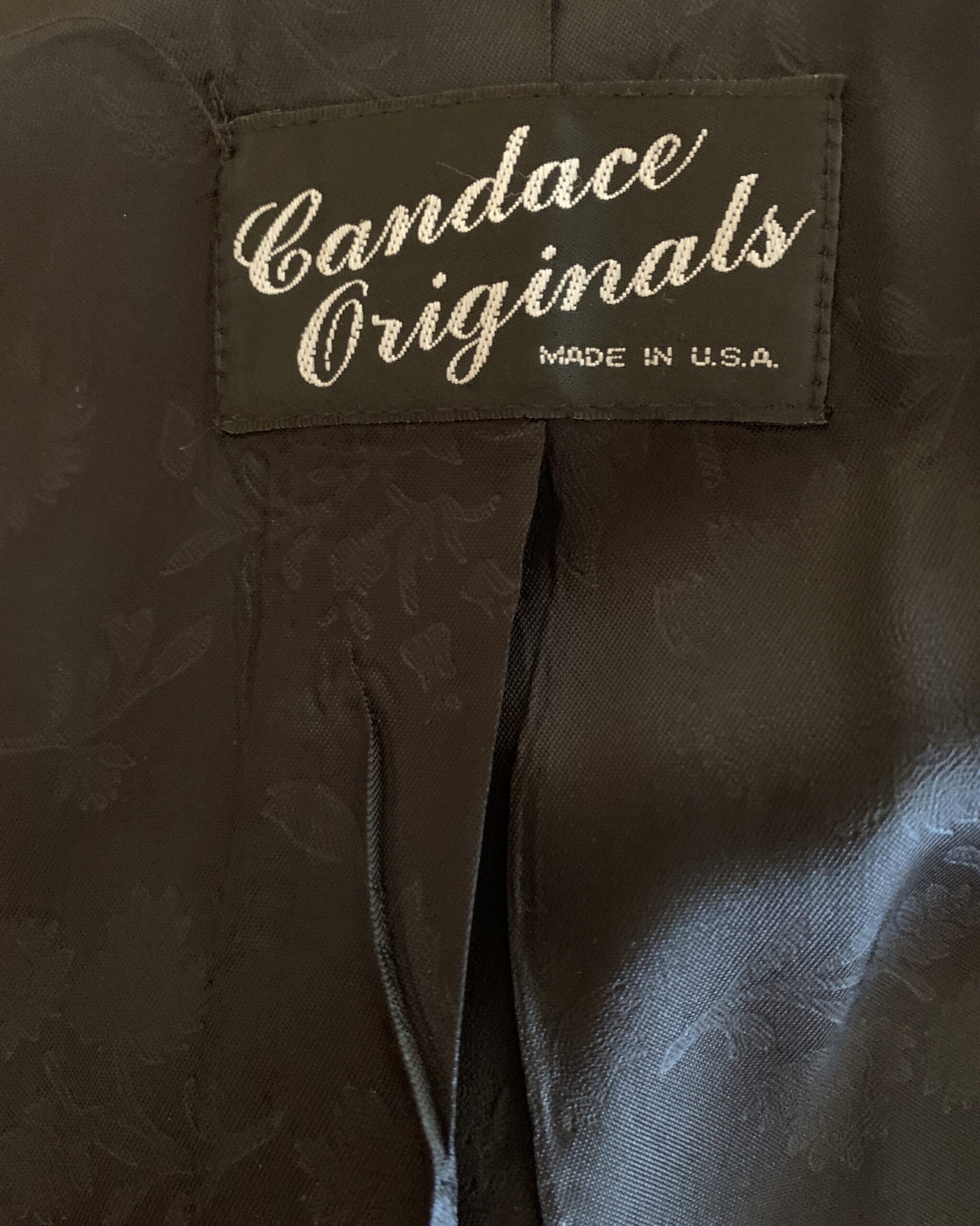 Candace Originals Made in U.S.A. label stitched inside a vintage black and white faux fur coat.
