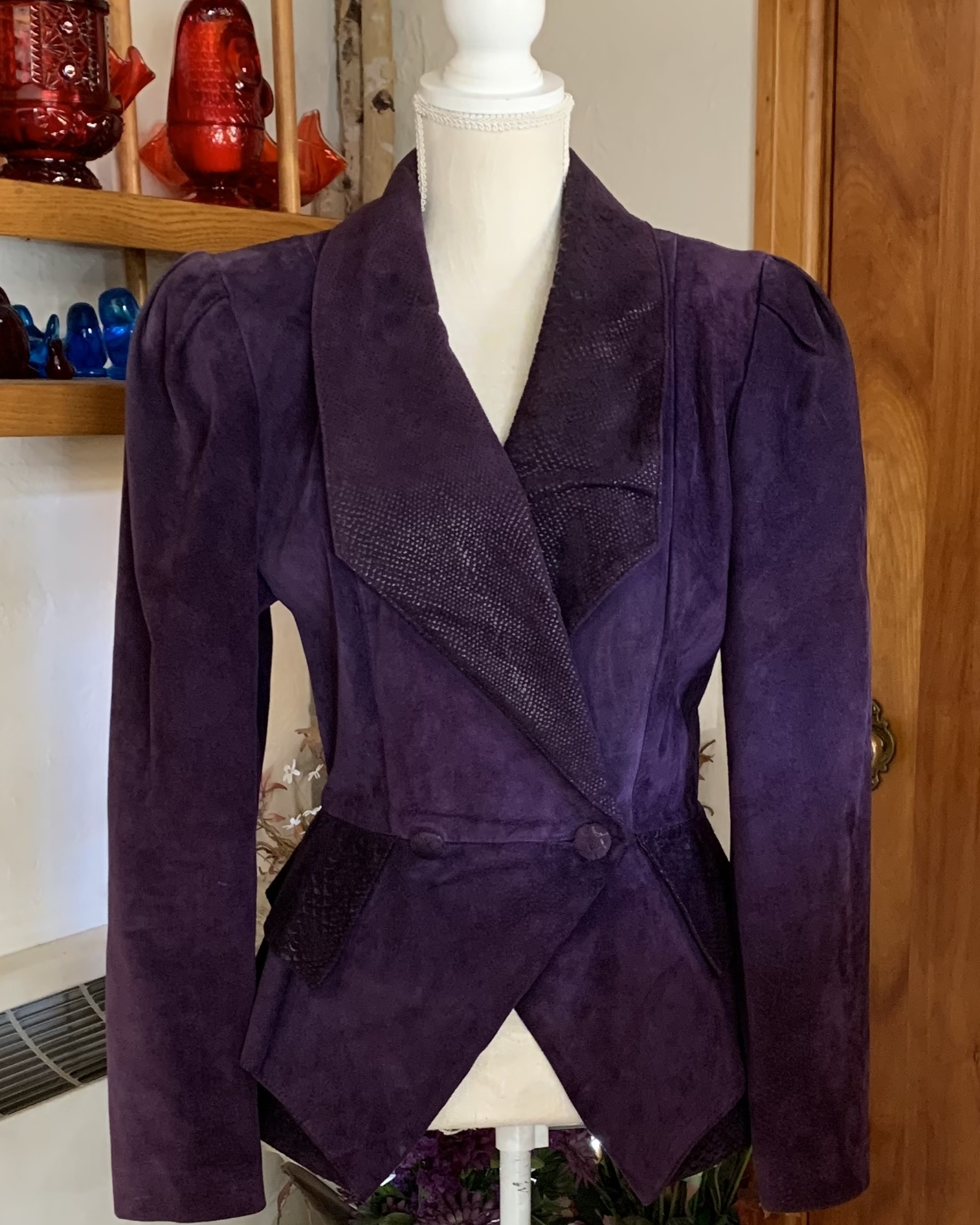 Vintage Danier purple suede jacket with structured shoulders and textured leather panel details displayed on mannequin.