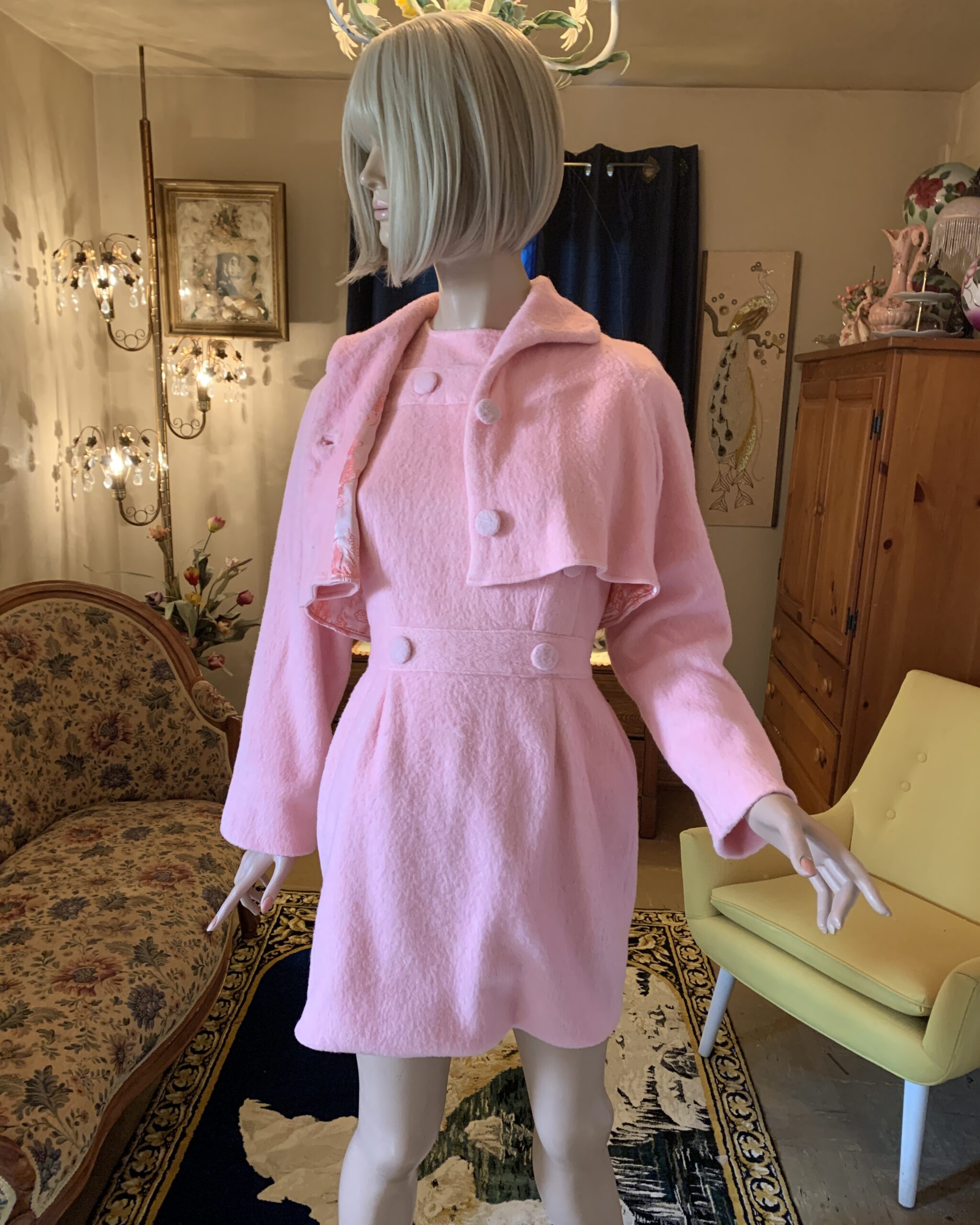 1960s pink brushed wool dress with matching capelet displayed on a mannequin in The Revolving Archive salon.