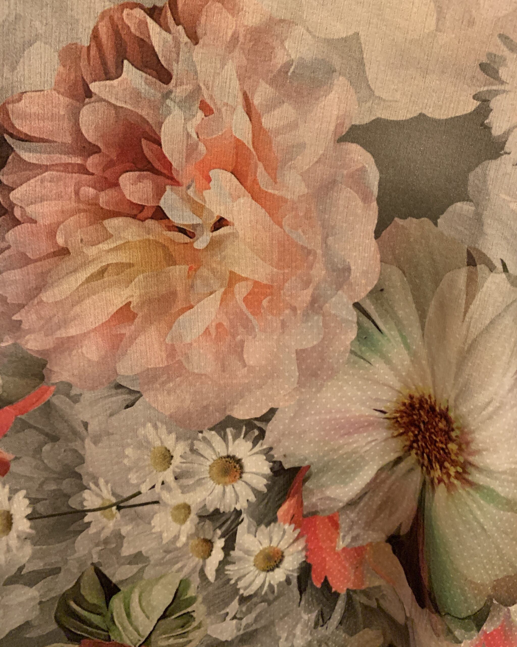 Close-up of the floral fabric featuring oversized pink blossoms, white daisies, and soft gray botanical elements on a vintage maxi dress.