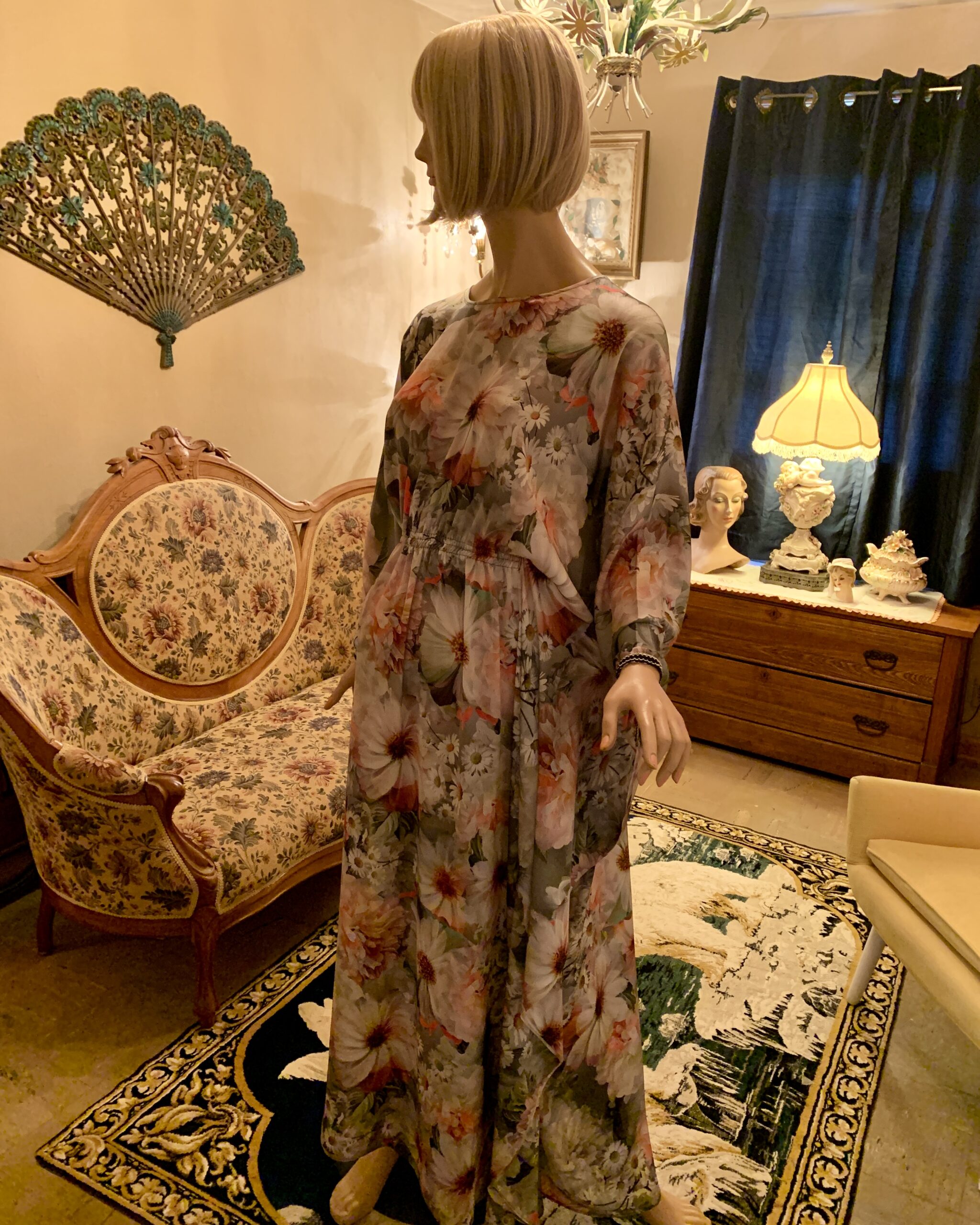 Vintage floral butterfly sleeve maxi dress with flowing wing sleeves and an allover botanical print, shown from the side.