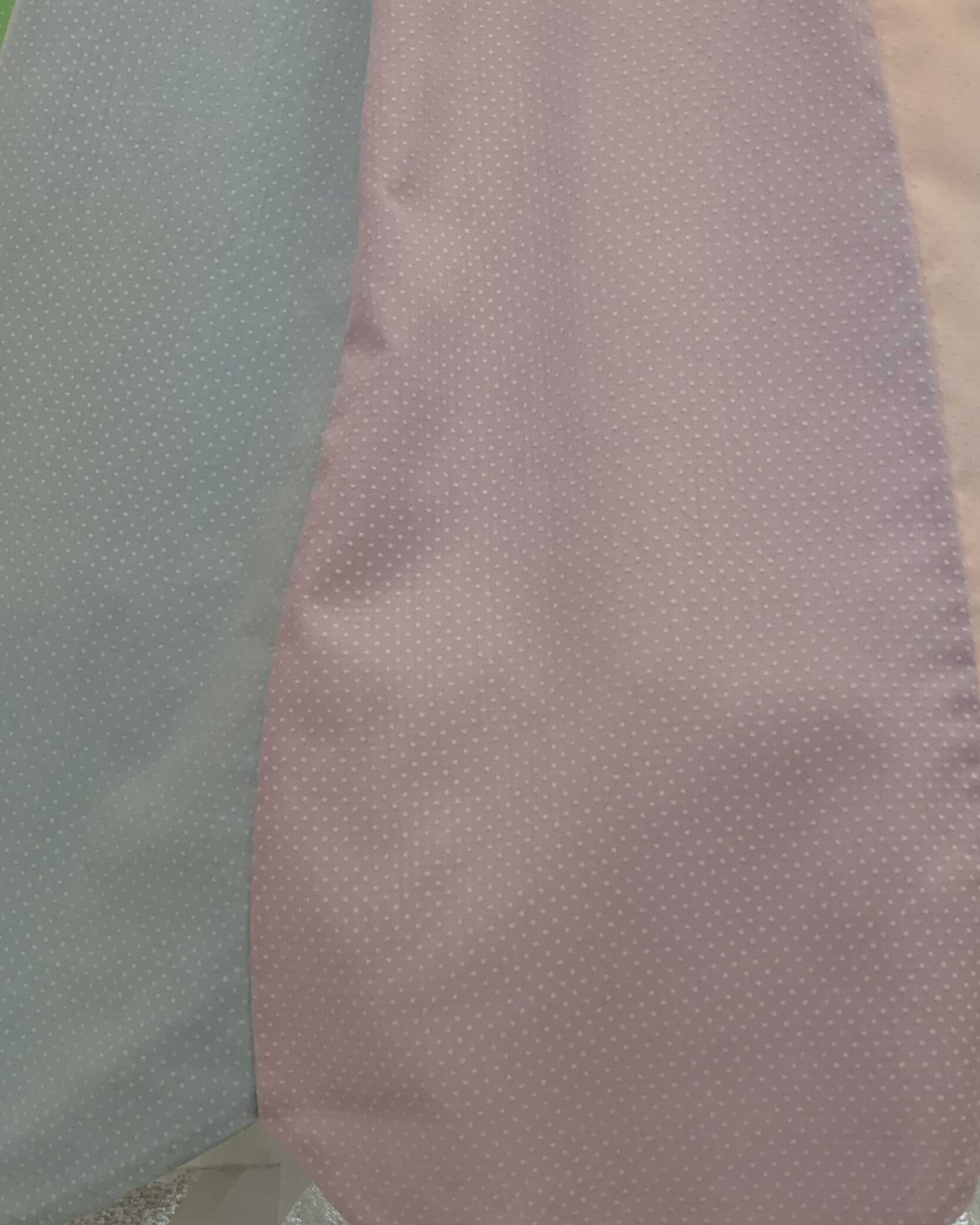 Close-up of pastel blue and pink dotted cotton fabric used in a handmade prairie dress from The Seamstress Collection.
