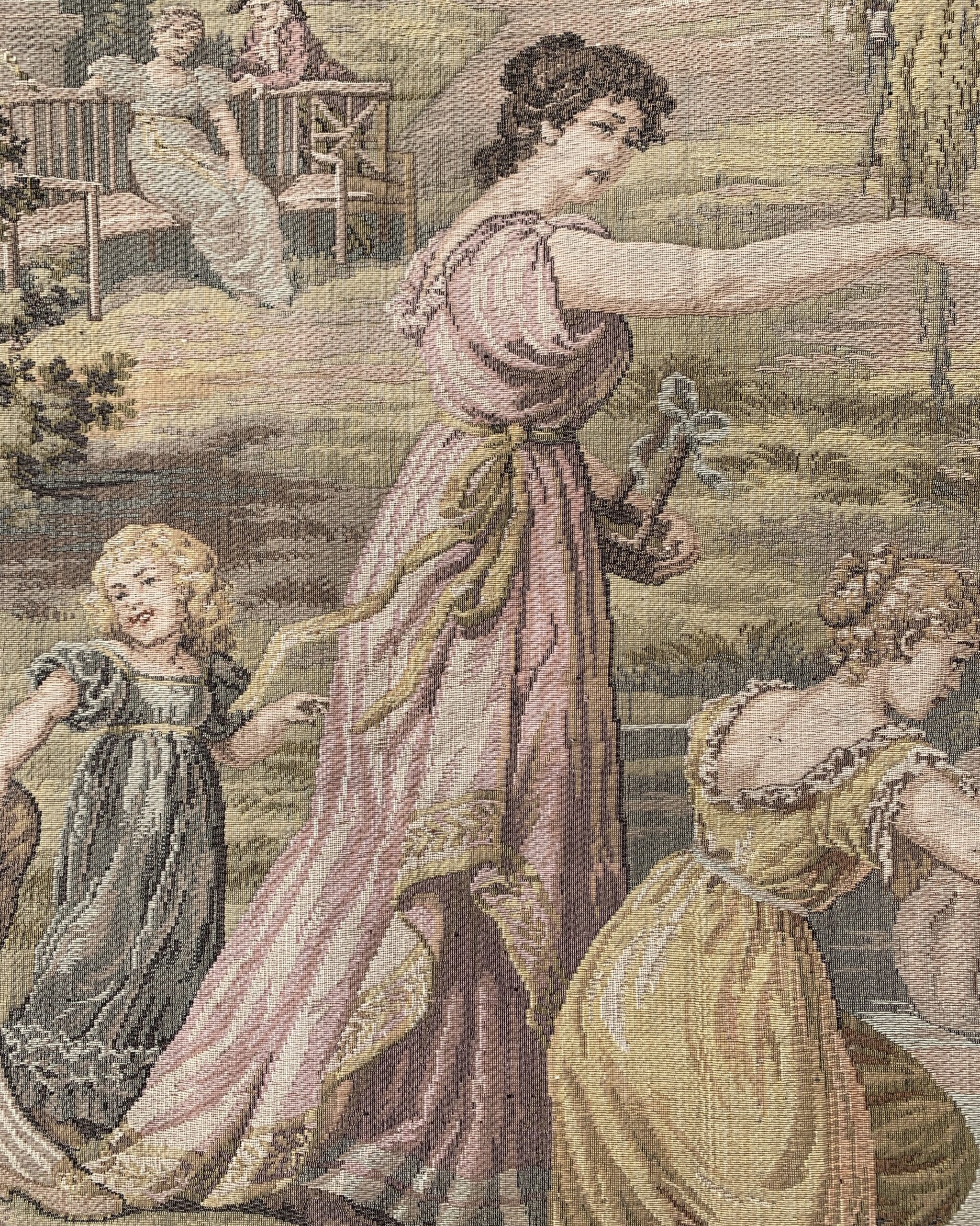 Detail of a woman in a flowing pink Empire-style gown holding flowers beside a garden pond in a woven tapestry.