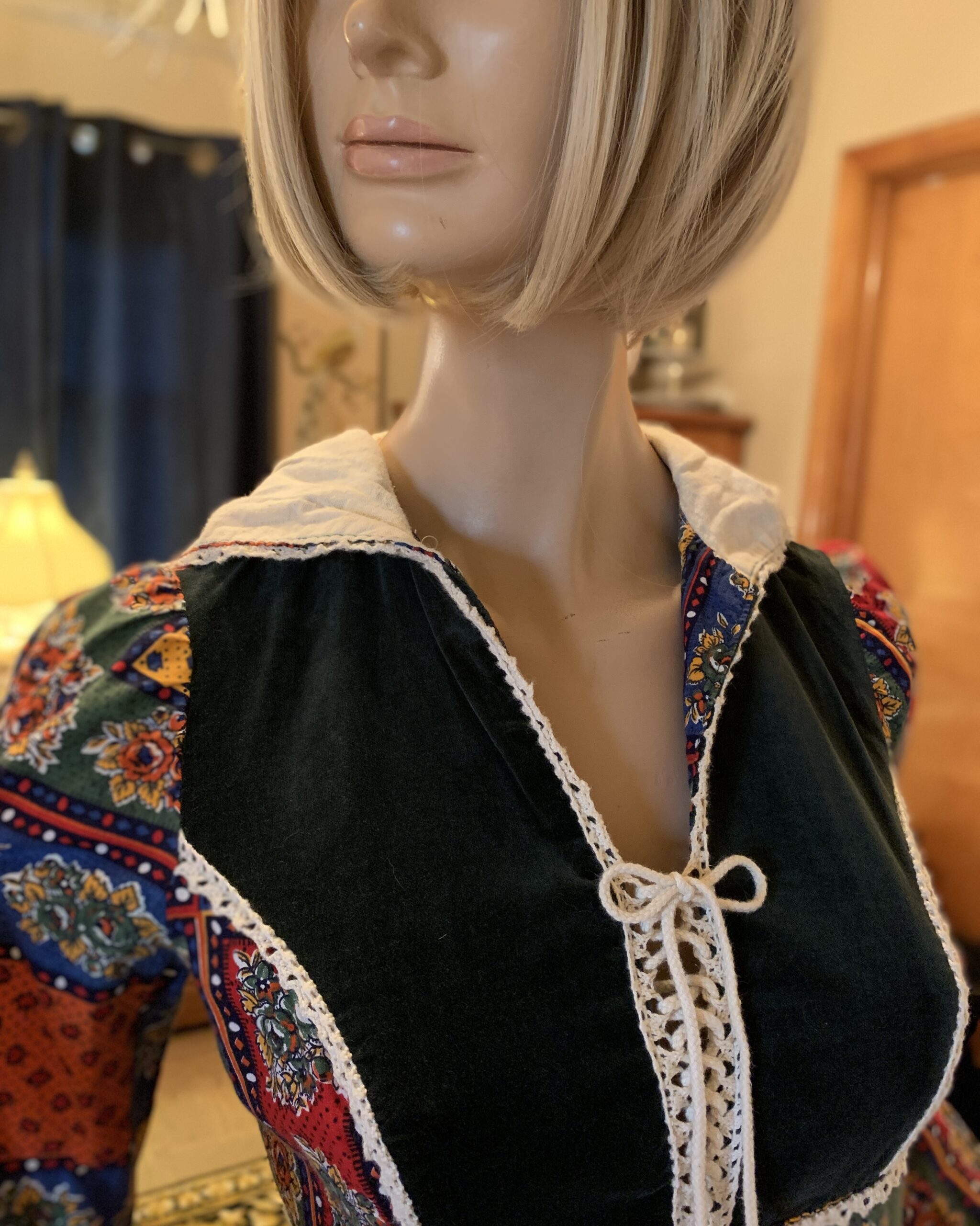 Close-up of velvet lace-up bodice with crochet trim on vintage prairie dress