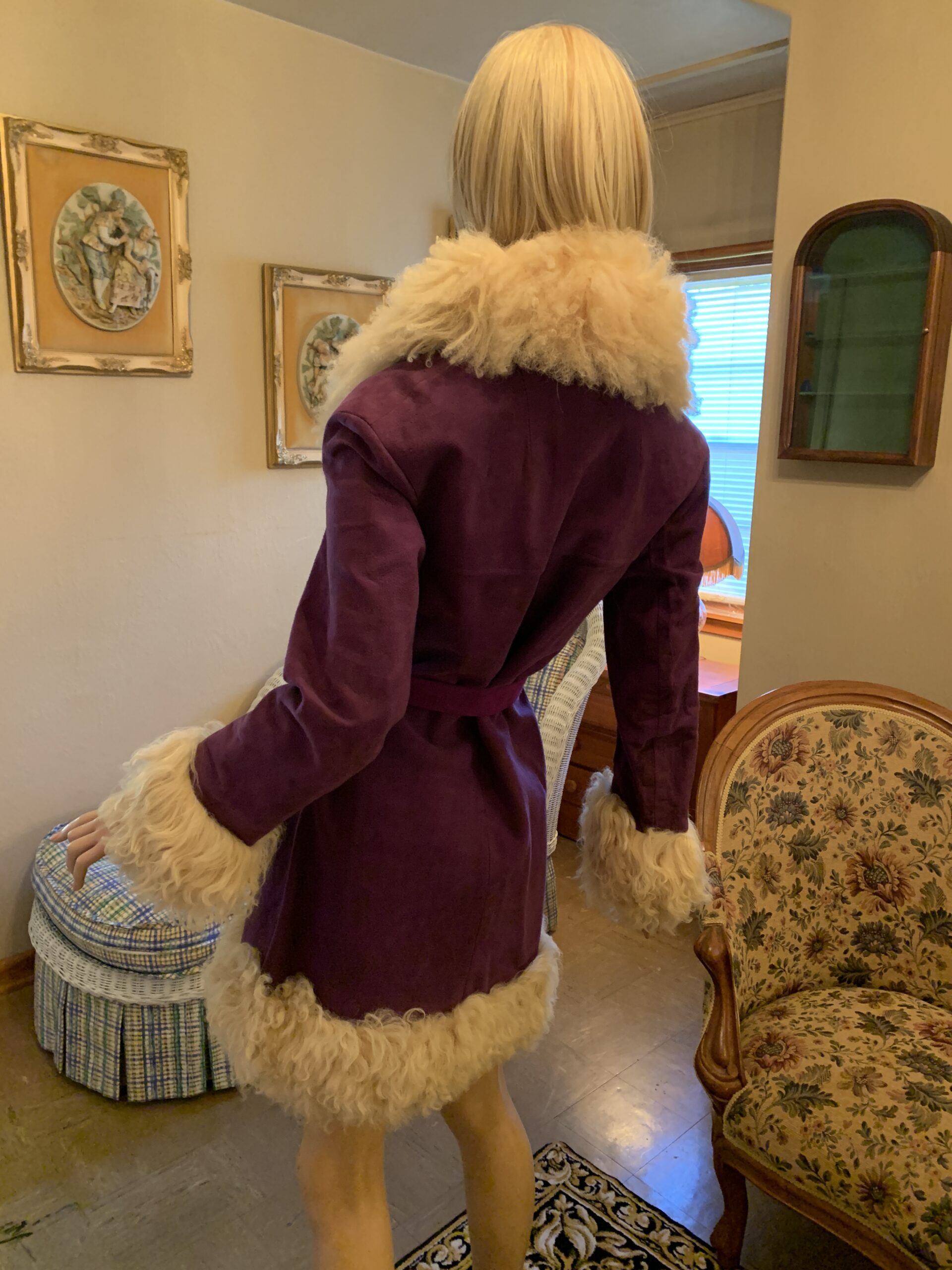 Back view of a vintage purple Lilli Ann coat with cream shearling collar, cuffs, and hem trim.