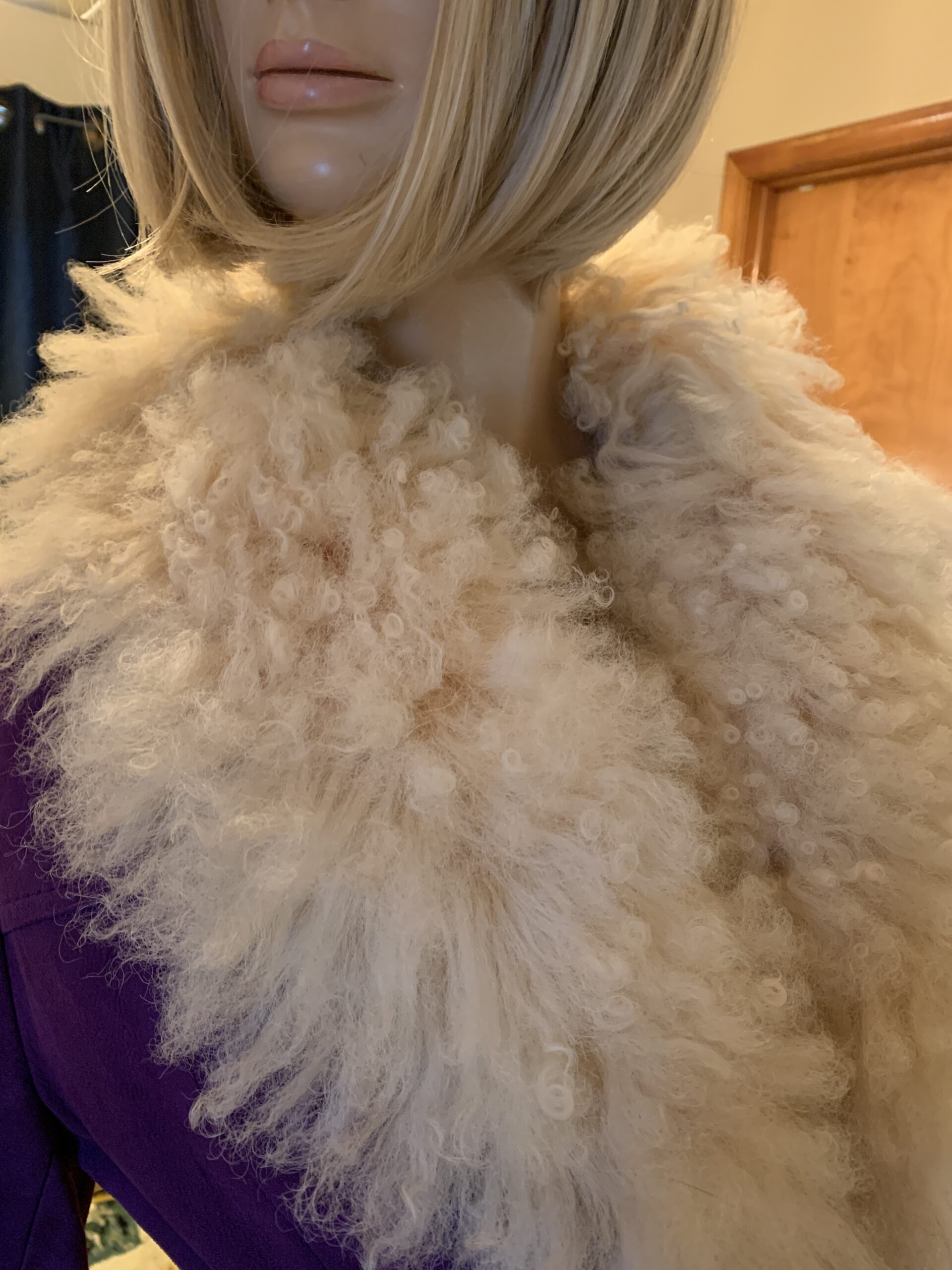 Oversized cream shearling collar on a vintage Lilli Ann coat, showcasing the dramatic neckline and natural texture.