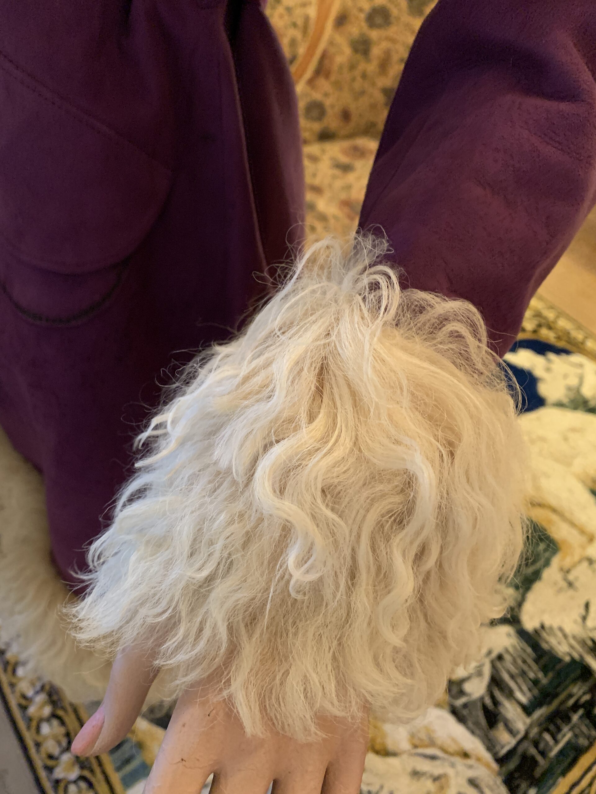 Cream curly shearling cuff detail on a vintage purple Lilli Ann coat, highlighting texture and volum