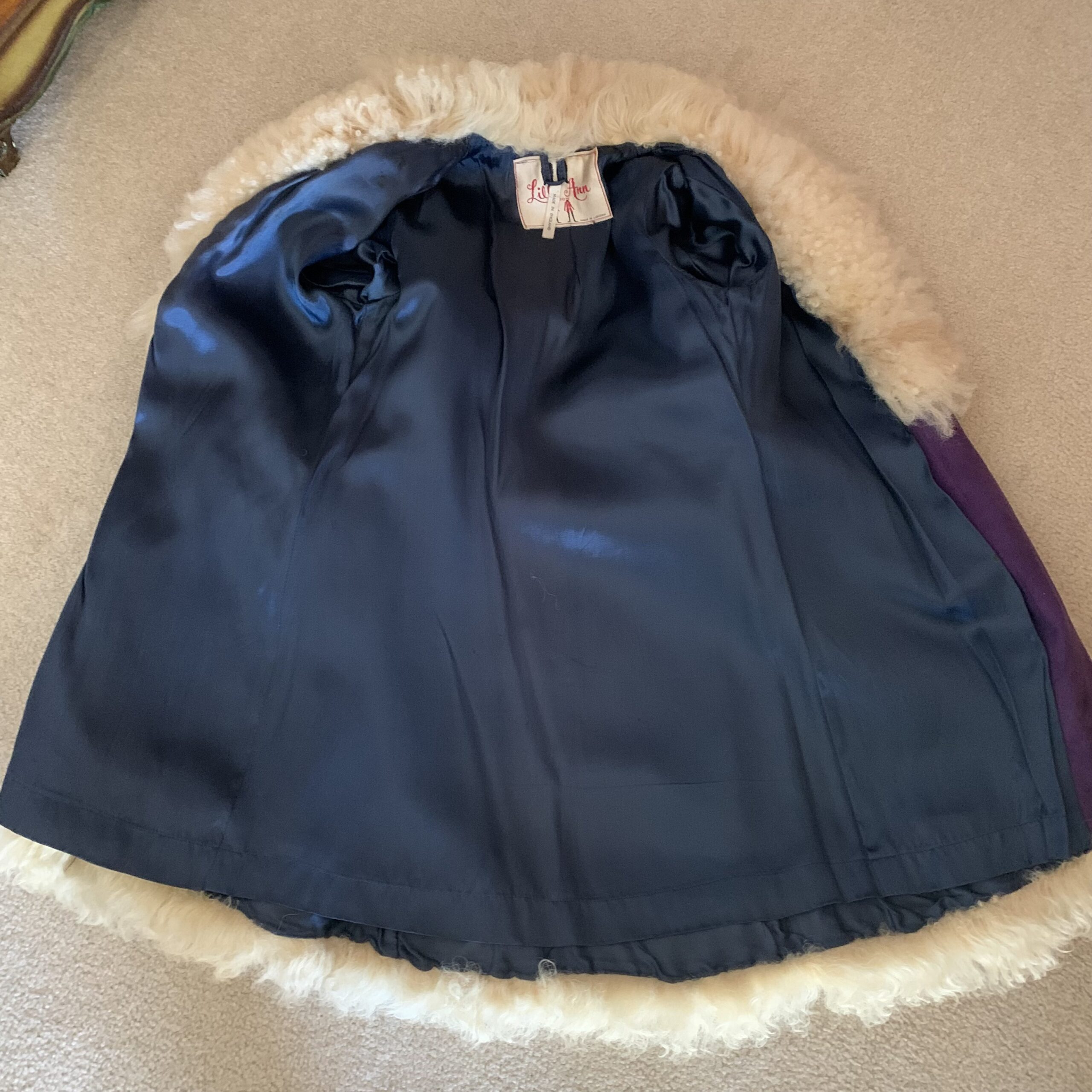 Sapphire blue satin lining inside a vintage Lilli Ann coat, showing the luxurious interior finish and craftsmanship.