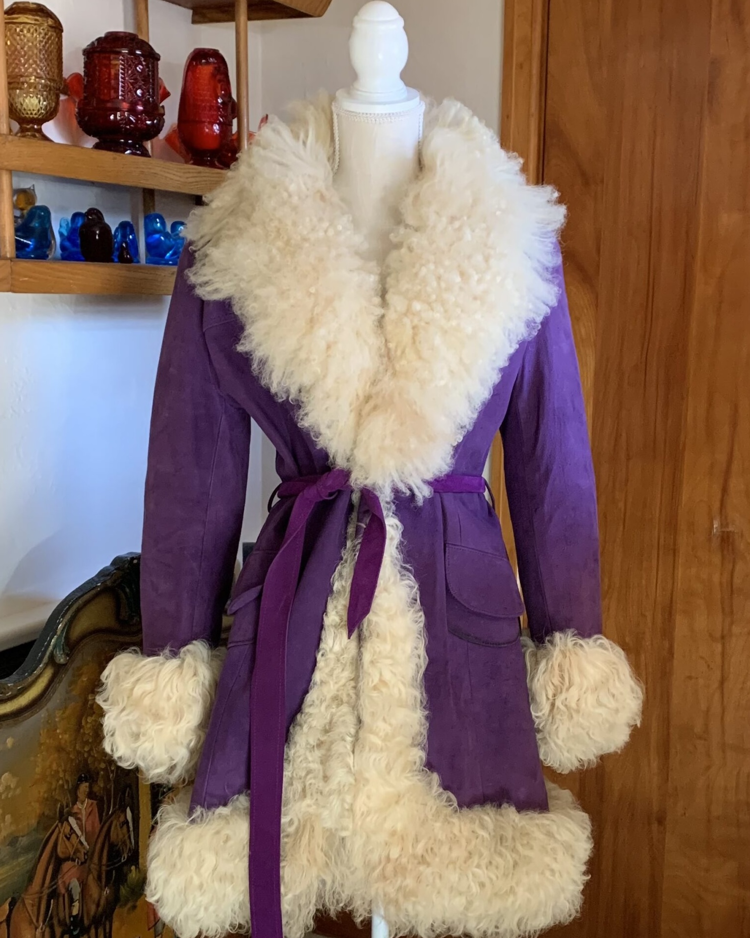 Purple Lilli Ann suede coat with cream Mongolian lamb trim and matching belt displayed on mannequin.