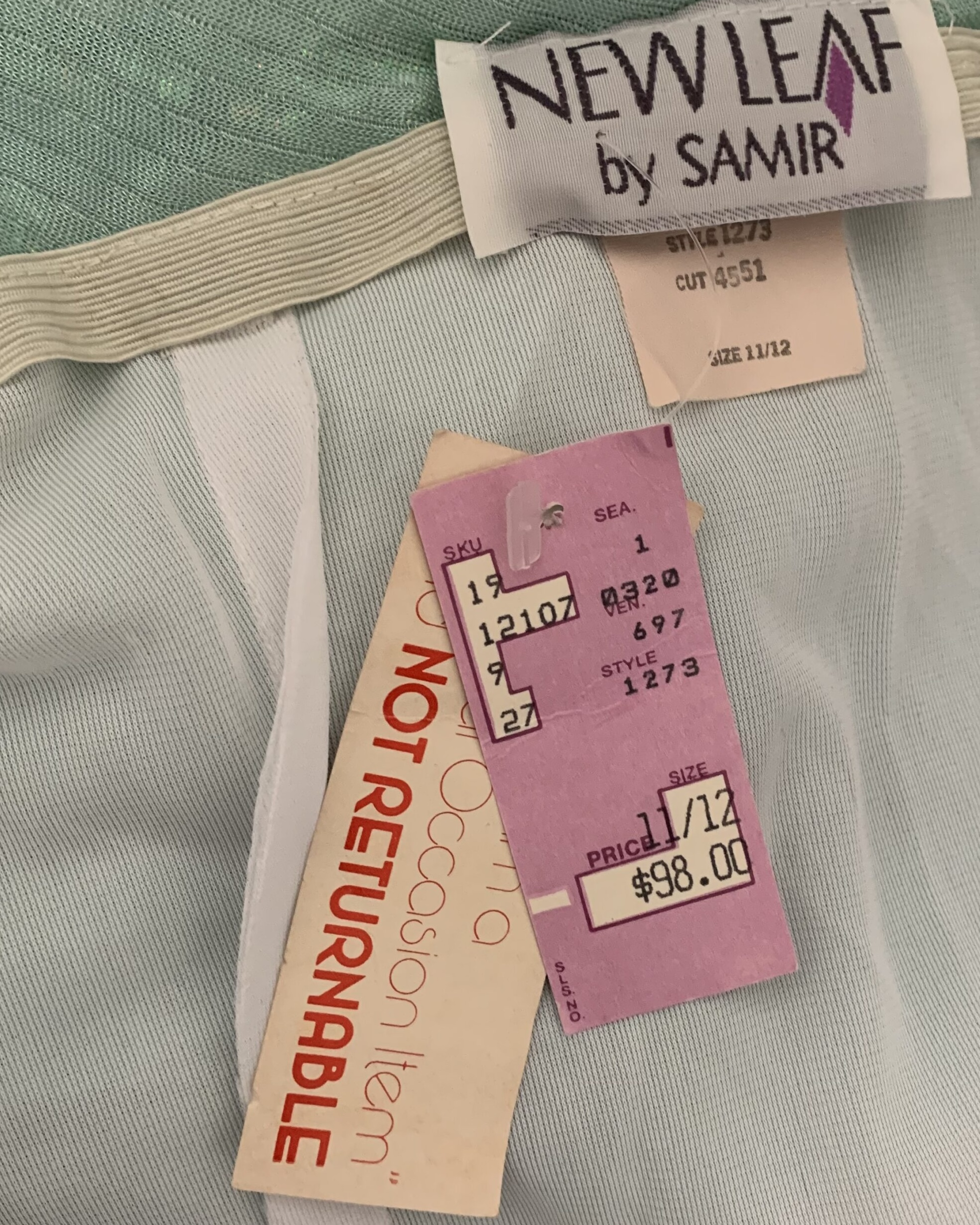 Original New Leaf by Samir label and attached vintage retail tags on a seafoam iridescent evening gown, including original $98 department store price tag and size label.