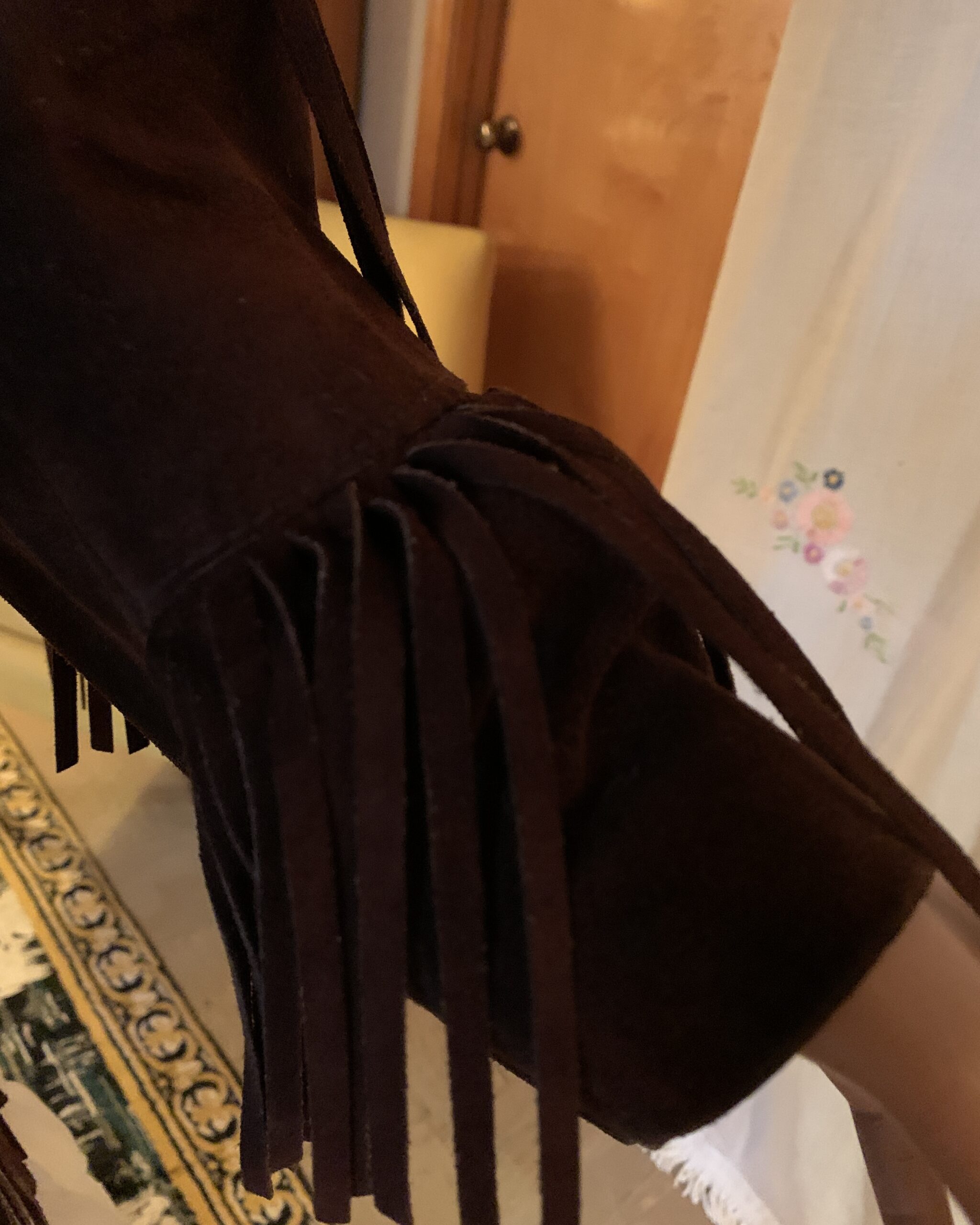 Close-up of the fringed suede cuff on a vintage Pioneer Wear Western jacket.