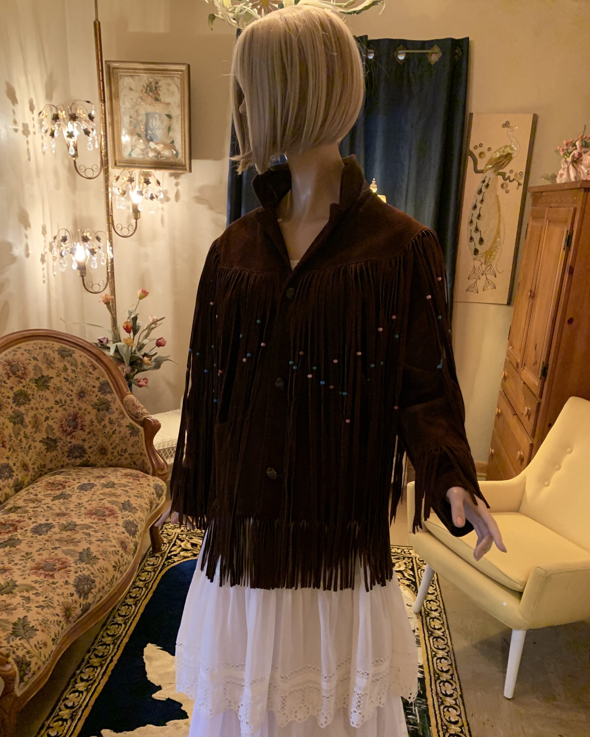 Front view of vintage Pioneer Wear chocolate brown suede fringe jacket with turquoise and pink beaded fringe details.