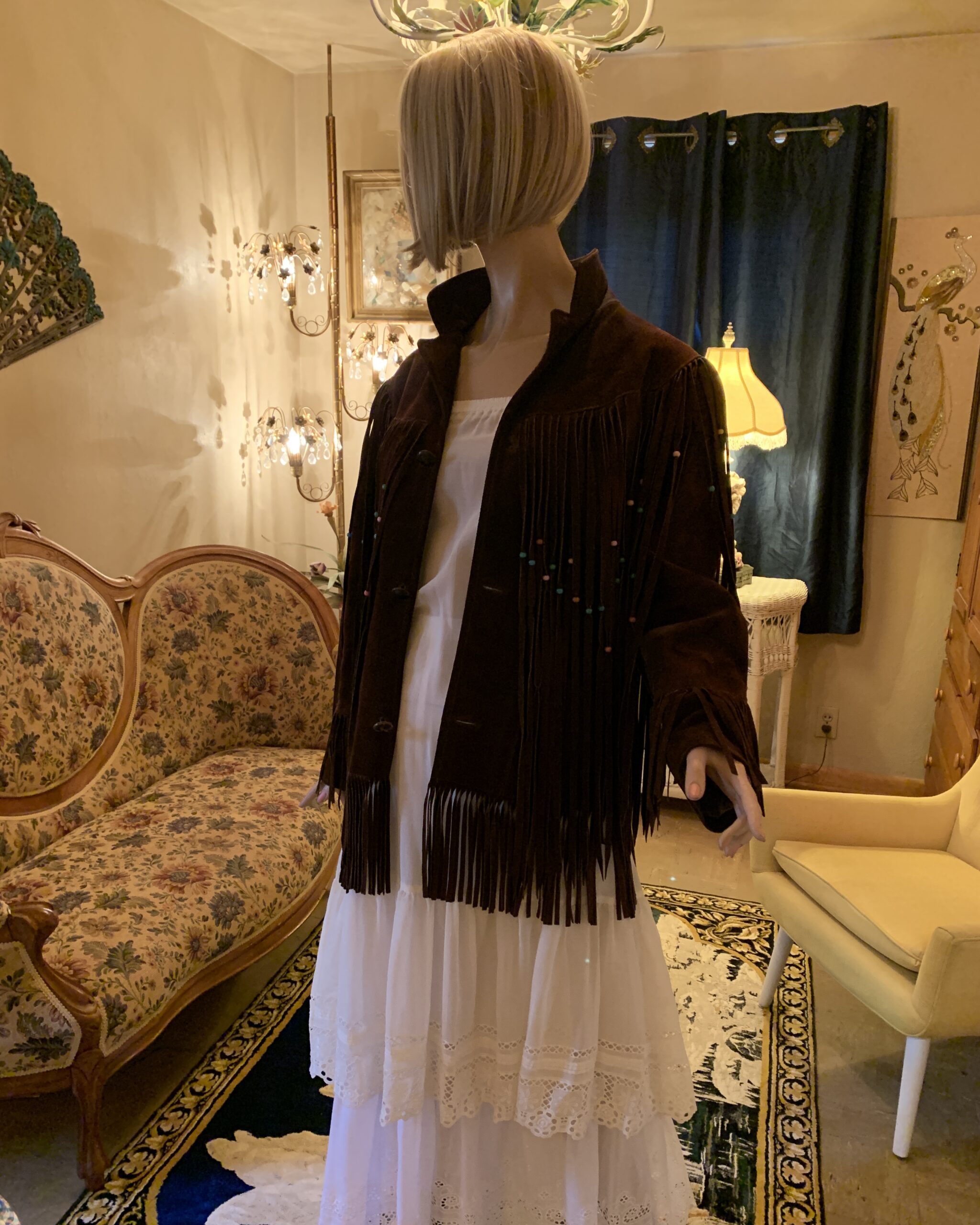 Vintage Pioneer Wear chocolate brown suede Western jacket with long beaded fringe and stand collar styled over a white prairie dress.
