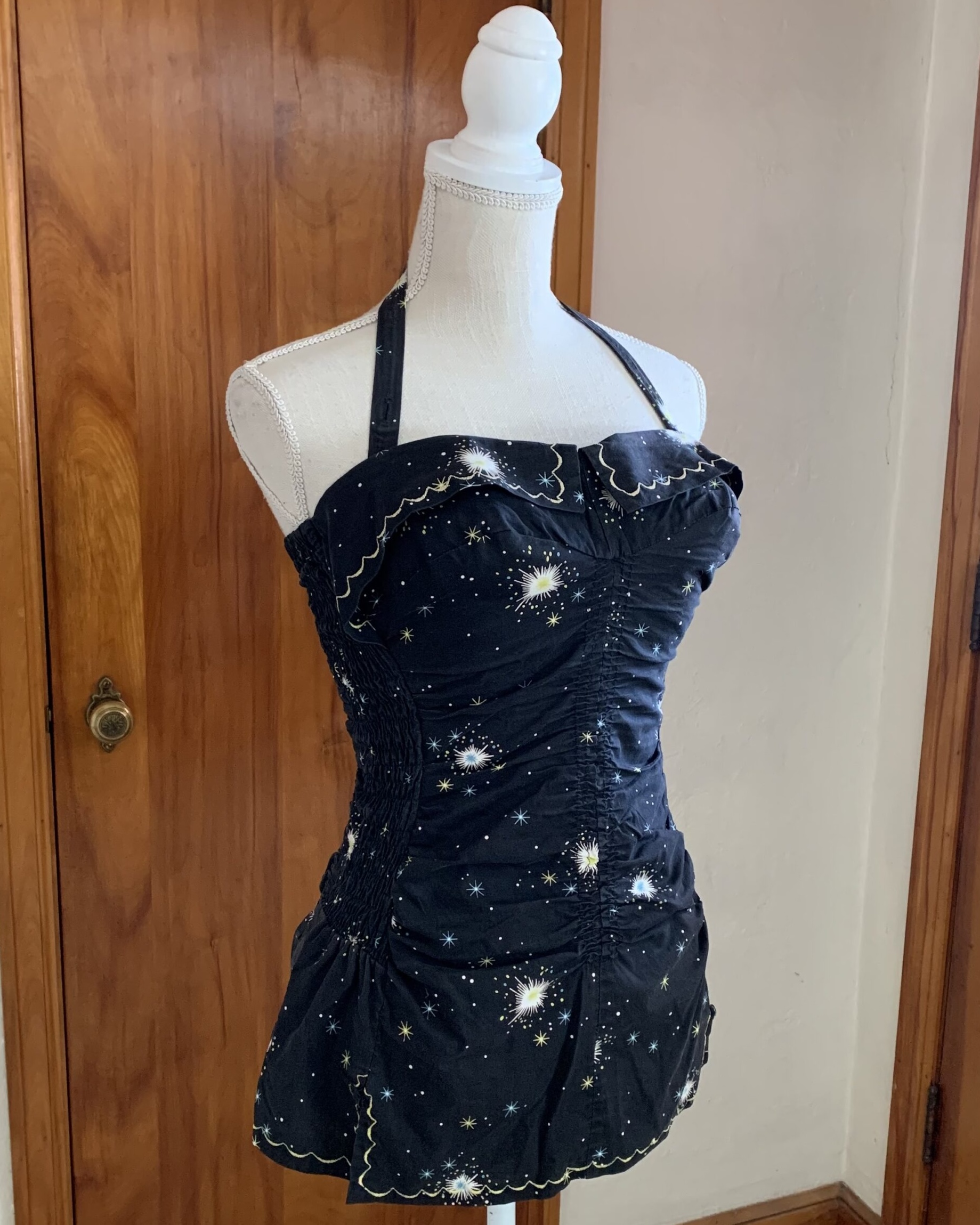 Side view of 1950s–1960s Sea Nymph celestial print swimsuit with gathered construction and peplum-style hips.