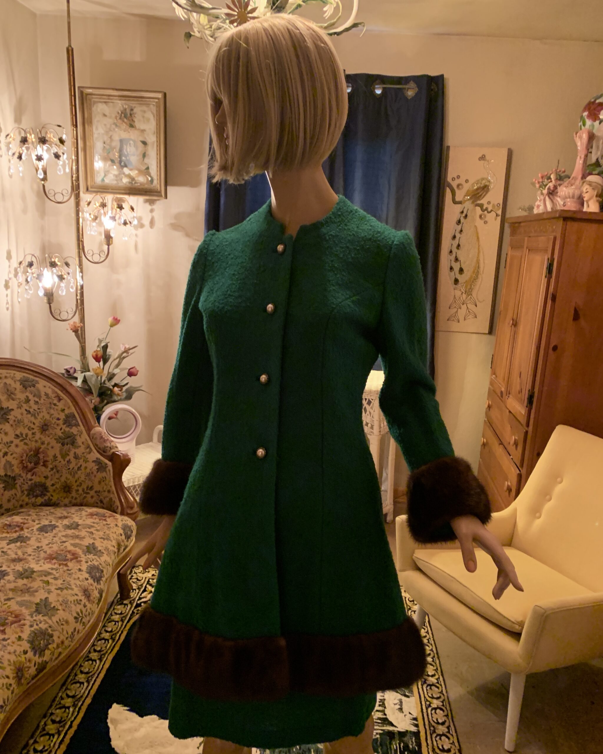 Front view of a vintage Lilli Ann emerald green wool coat dress featuring pearlized buttons, bracelet-length sleeves with mink cuffs, and a matching mink-trimmed hem.