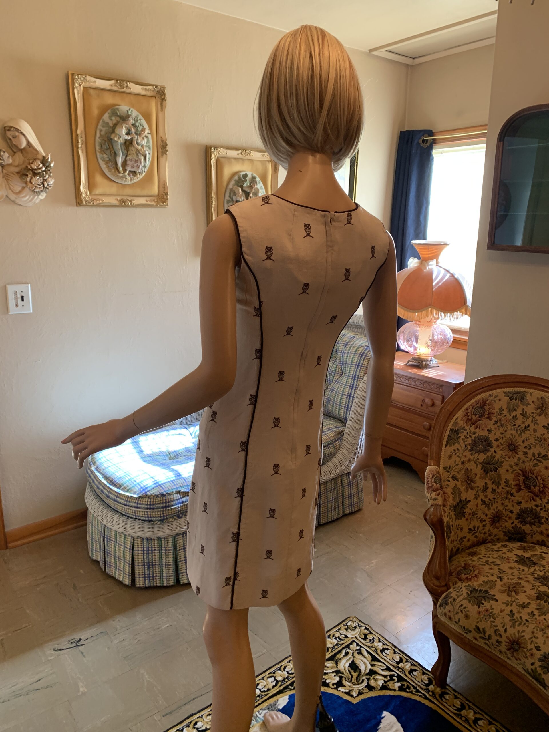 Back view of 1960s House of Lords owl print shift dress showing fitted shift silhouette, back zipper closure, and novelty owl pattern.
