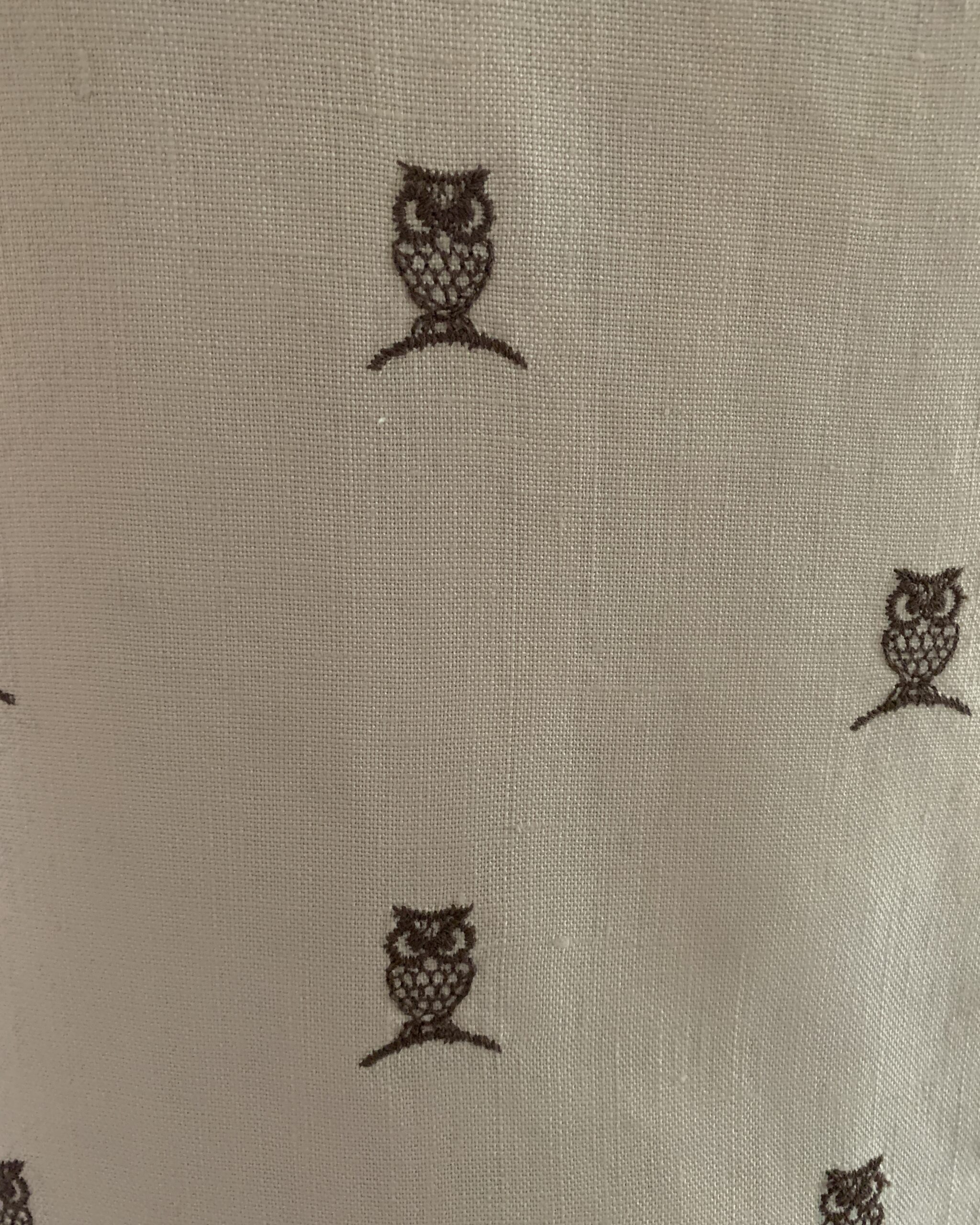 Close-up of novelty owl print on cream textured fabric from a 1960s House of Lords shift dress.