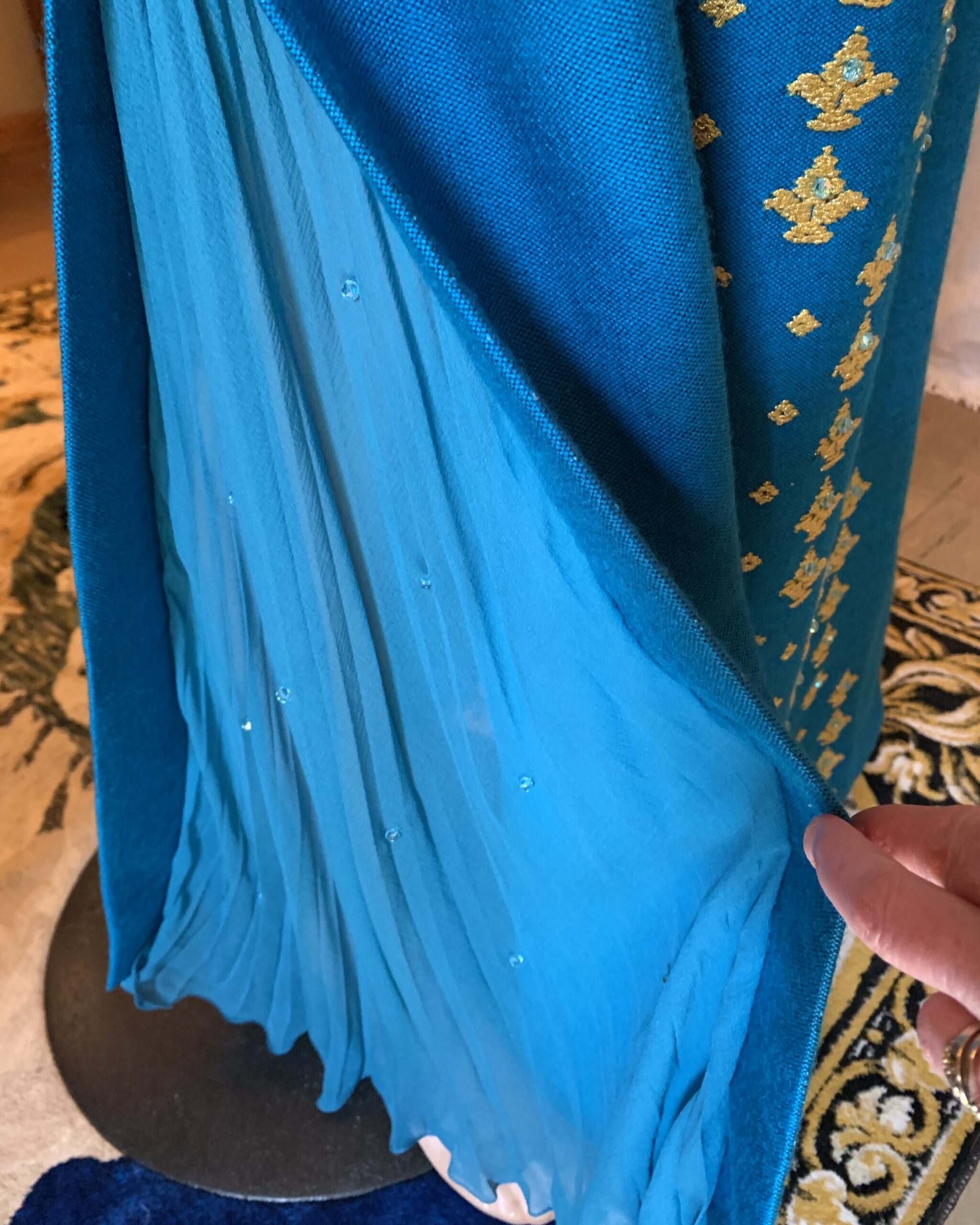 Interior sheer chiffon godet insert at hem of 1970s Nikos and Takis gown showing movement and layered construction.