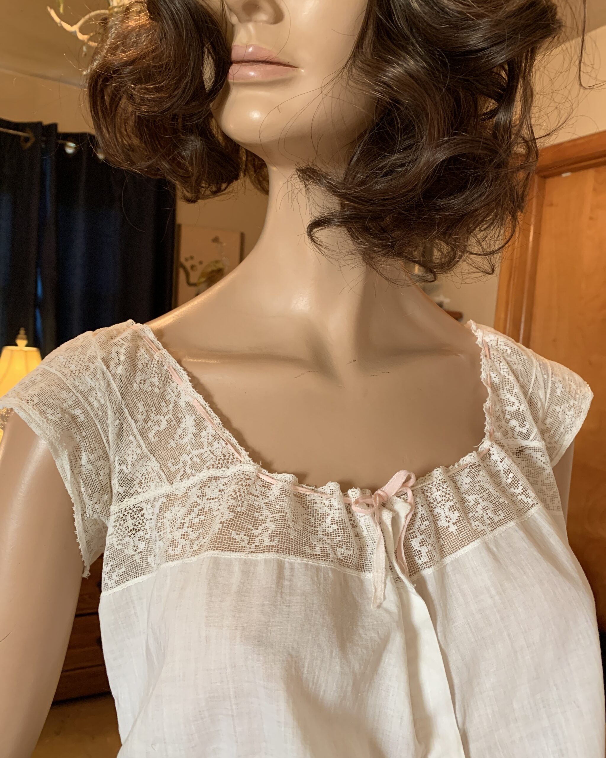 Close-up of Edwardian lace corset cover neckline with pink ribbon detail