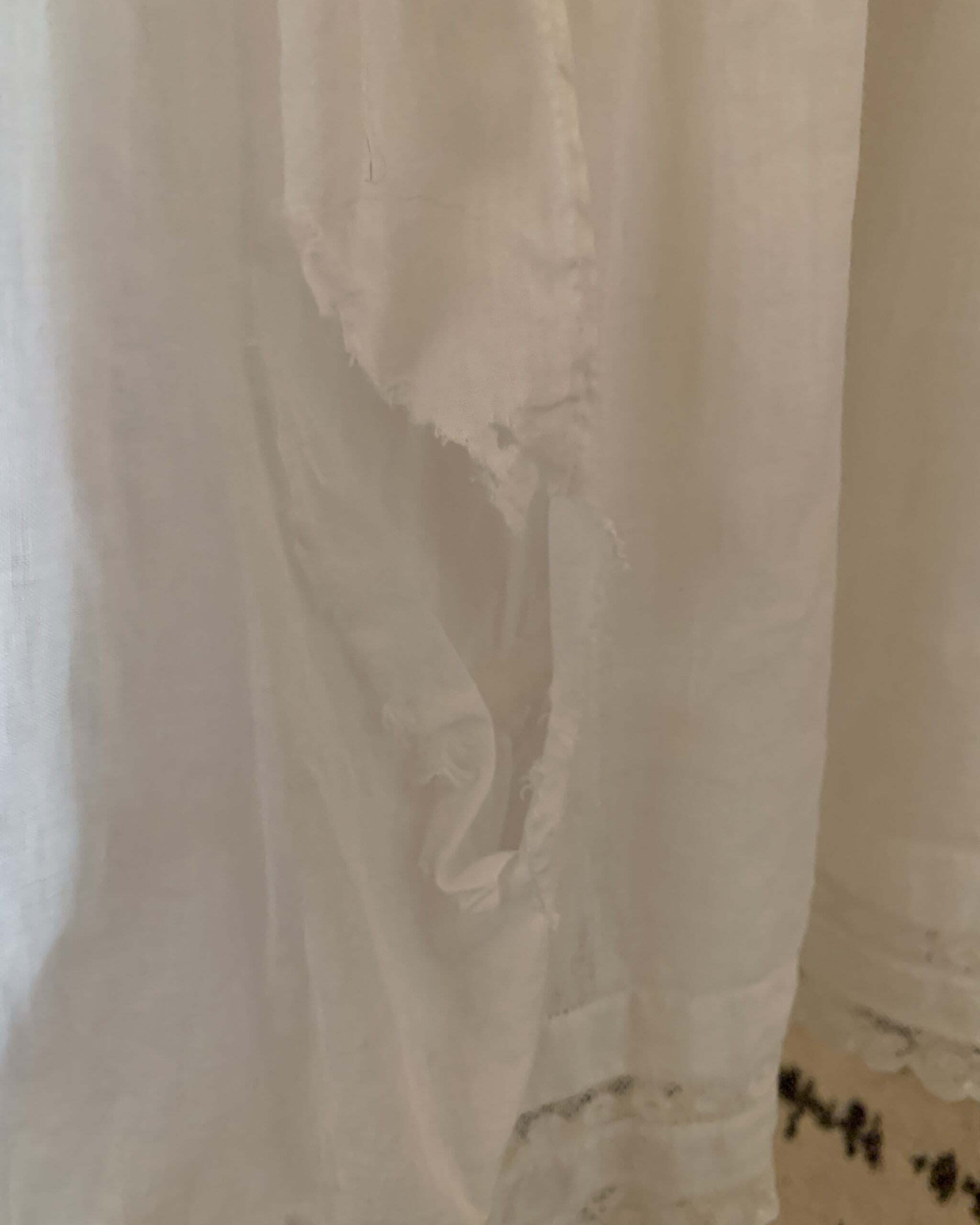 Close-up showing condition flaw and tear on antique Edwardian petticoat skirt