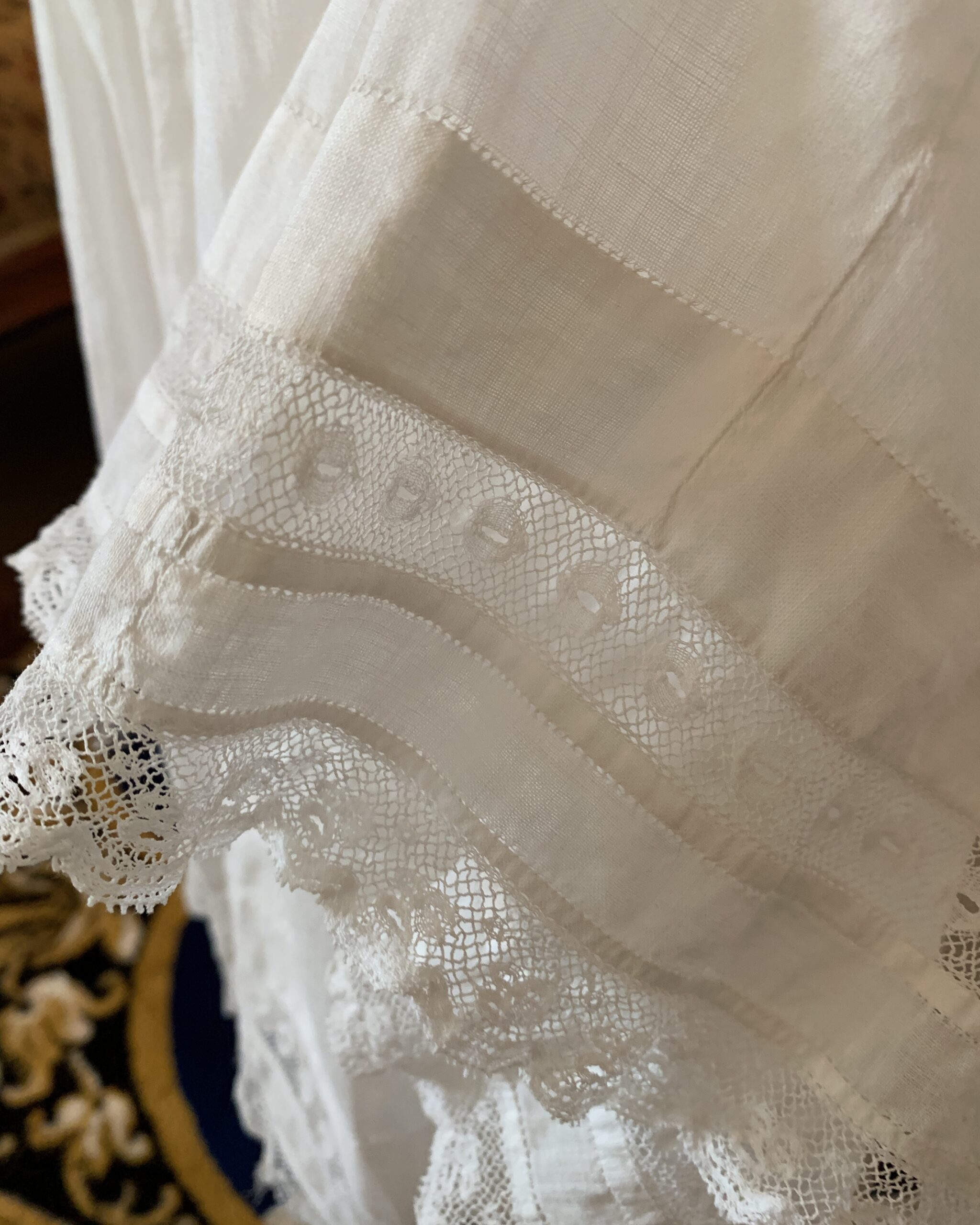 Close-up of antique petticoat hem with lace trim and gathered construction