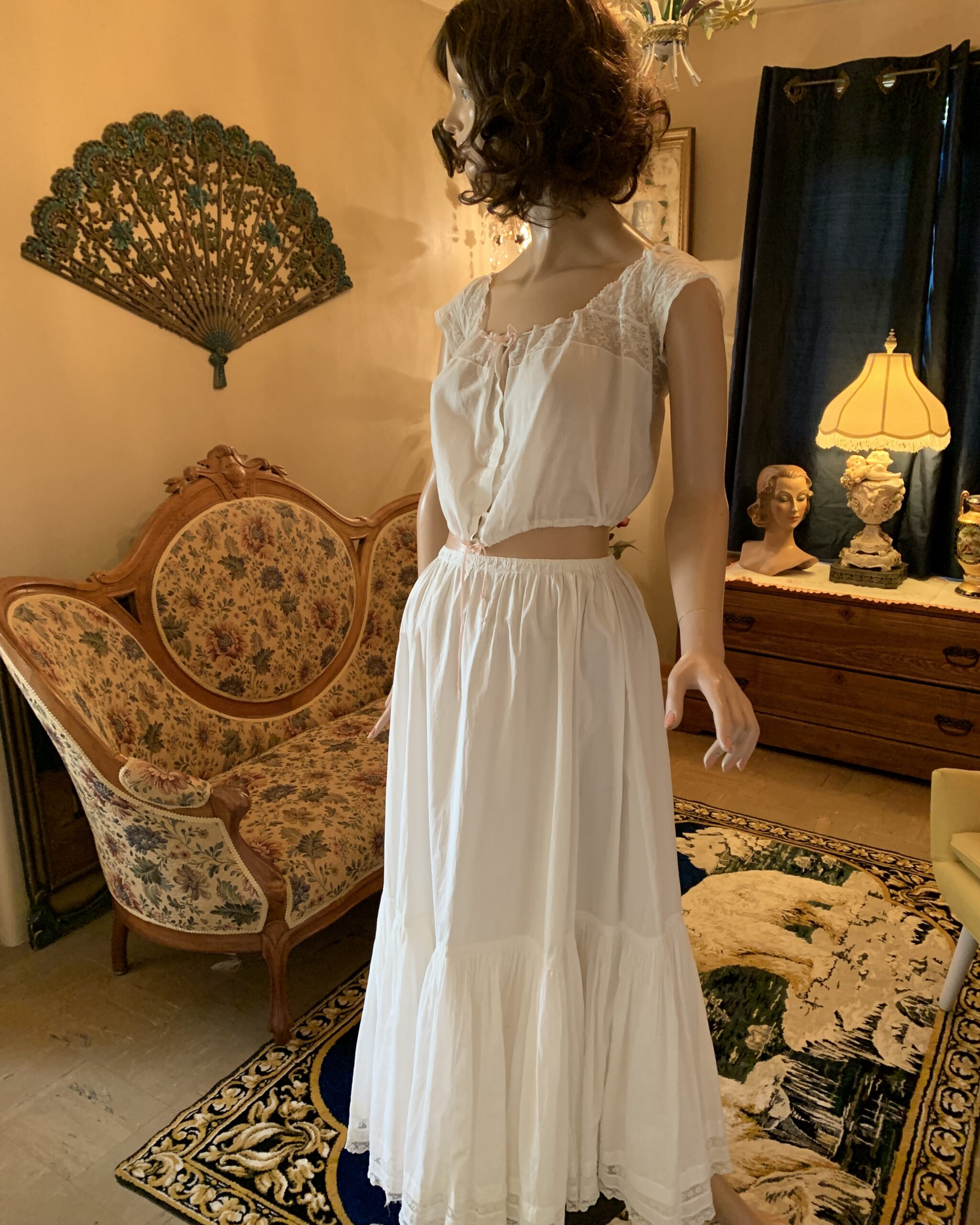 Edwardian white cotton corset cover and petticoat set with lace trim and gathered skirt displayed on mannequin