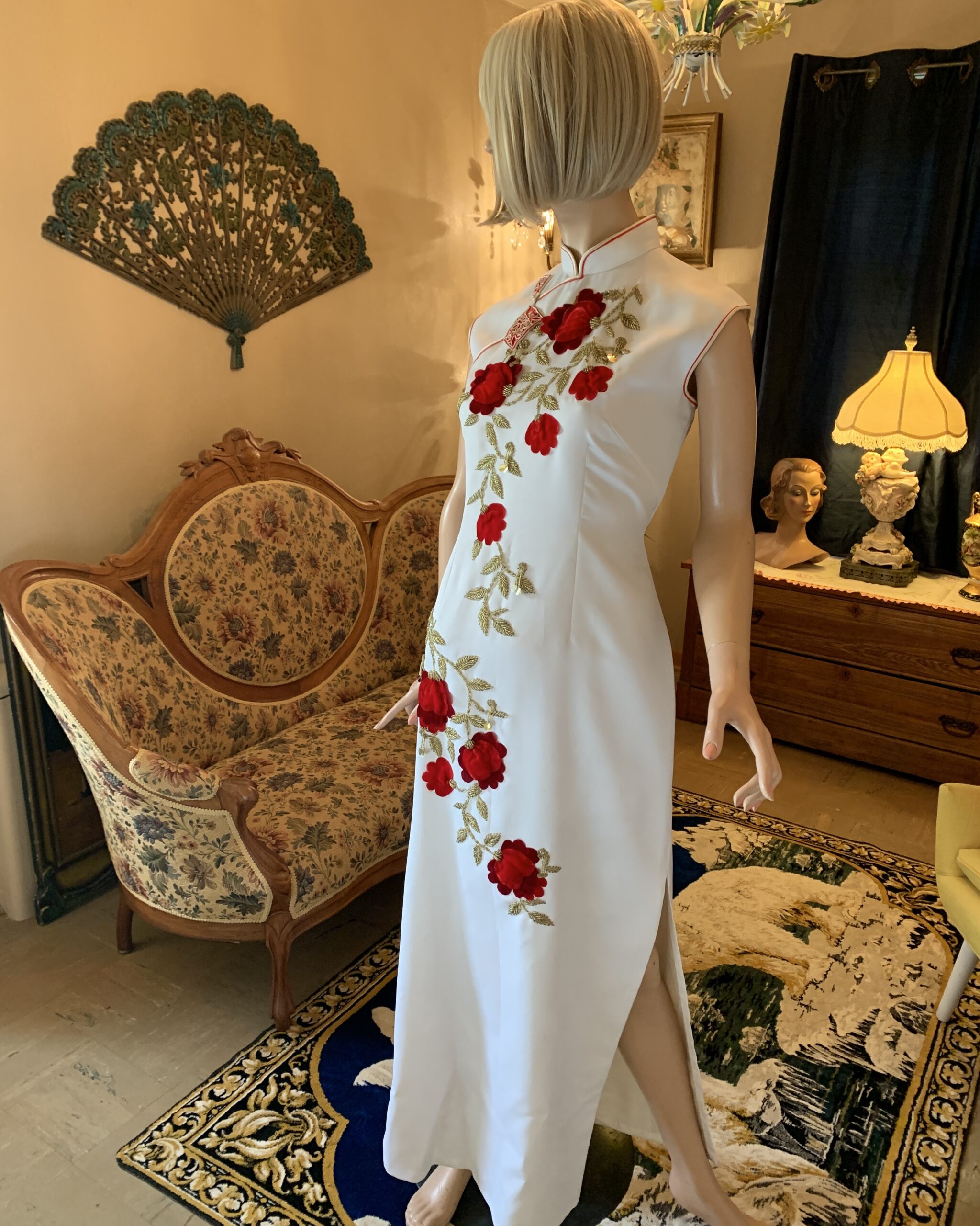 Vintage ivory Chinese-inspired evening gown featuring dimensional red velvet flowers, gold beaded vines, high collar, and side slit.