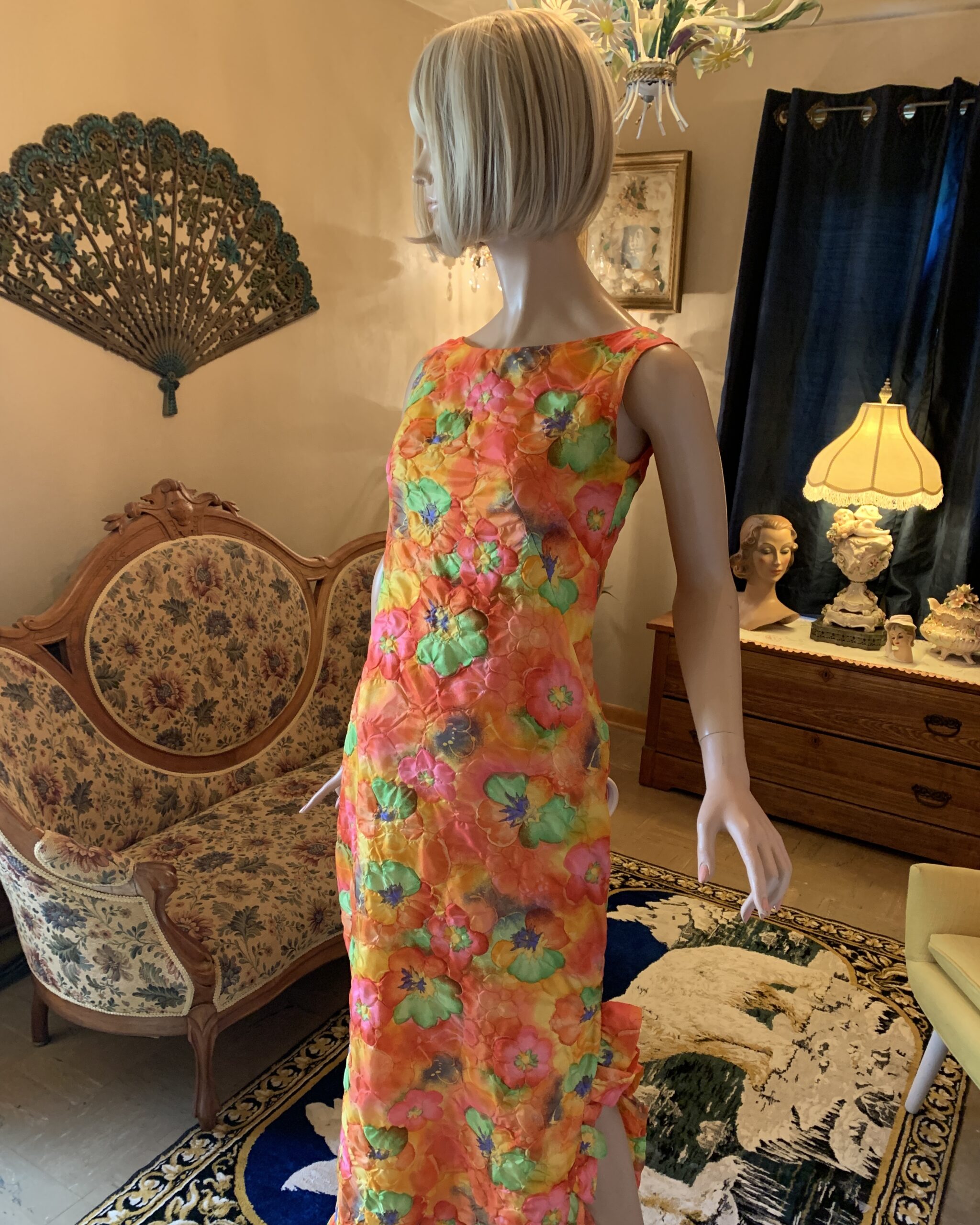 Side view of a vintage psychedelic floral maxi dress with a lightweight quilted texture and ruffled hem.
