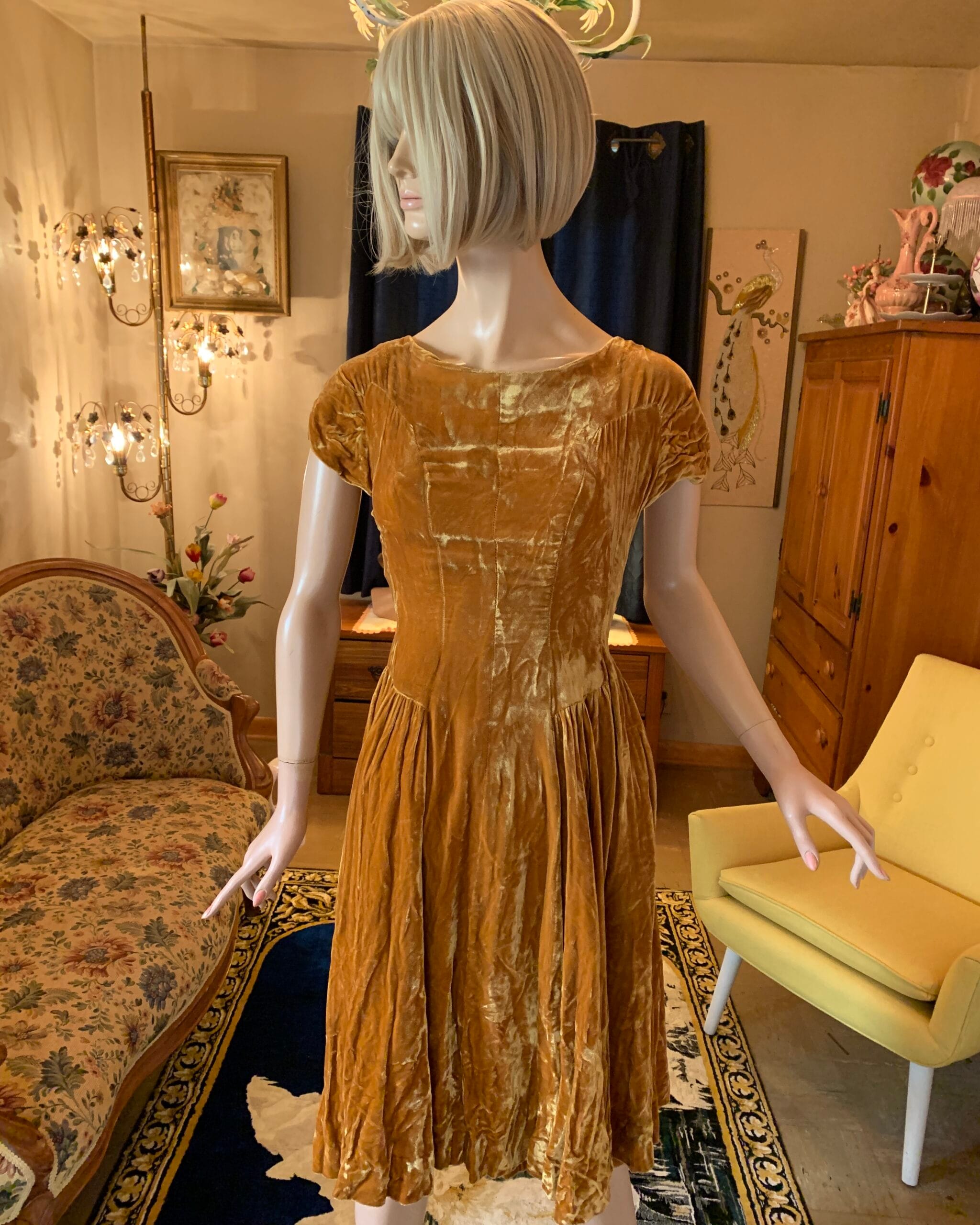 Front view of a vintage golden velvet dress featuring a softly fitted waist, cap sleeves, and rich velvet texture.