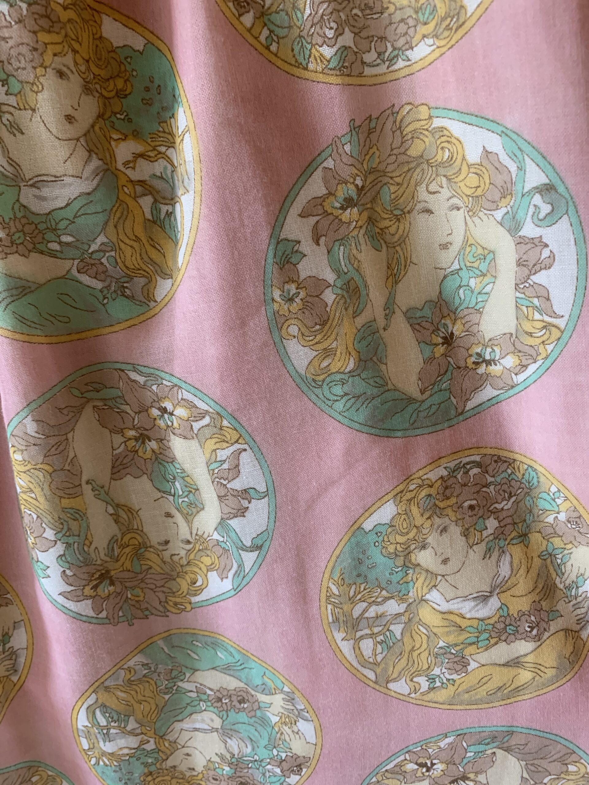Close-up of Art Nouveau-inspired portrait print in pastel pink, mint, and golden tones.