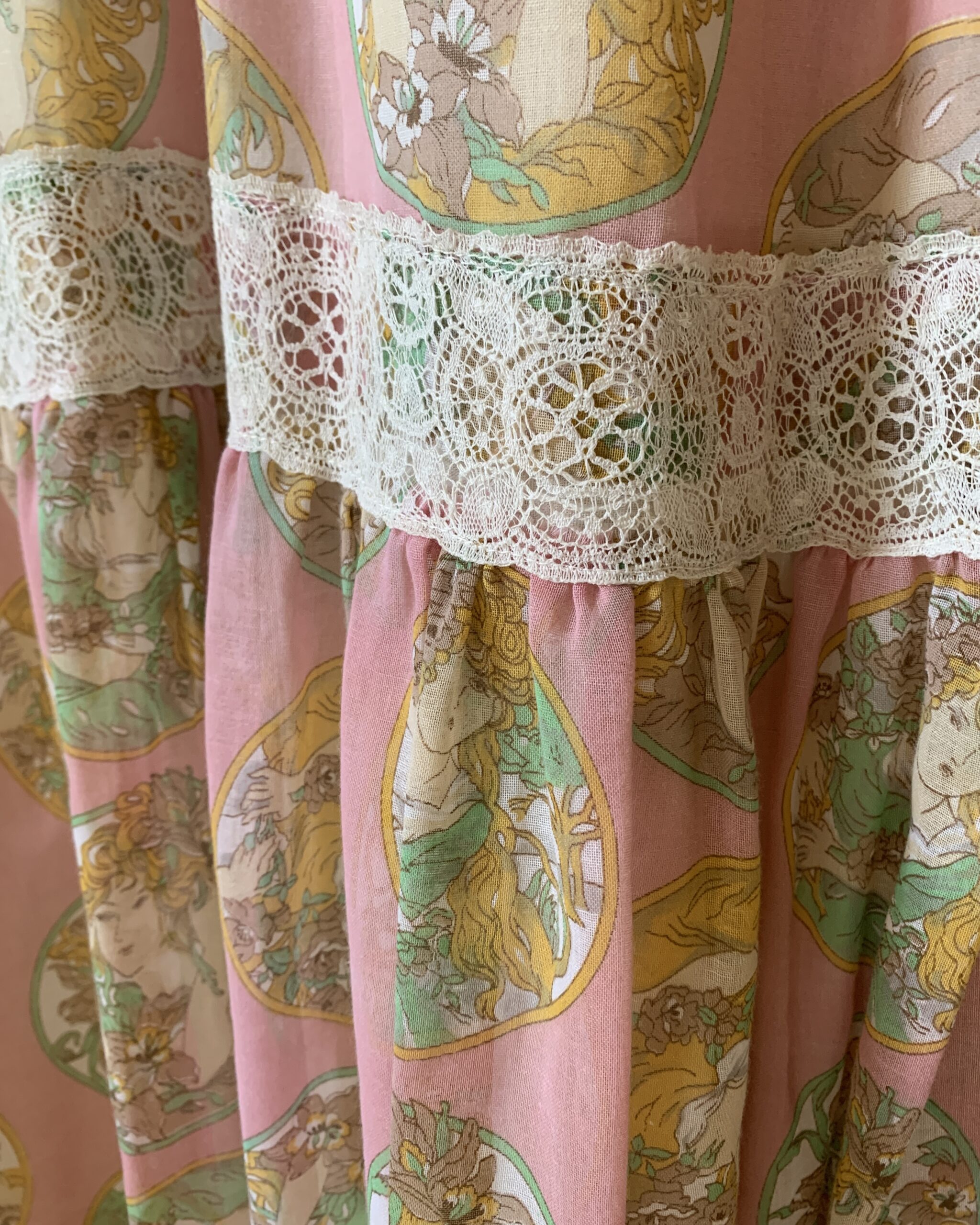 Detailed view of lace insertion trim and gathered skirt tier on Susan Lane Mother Hubbard dress.