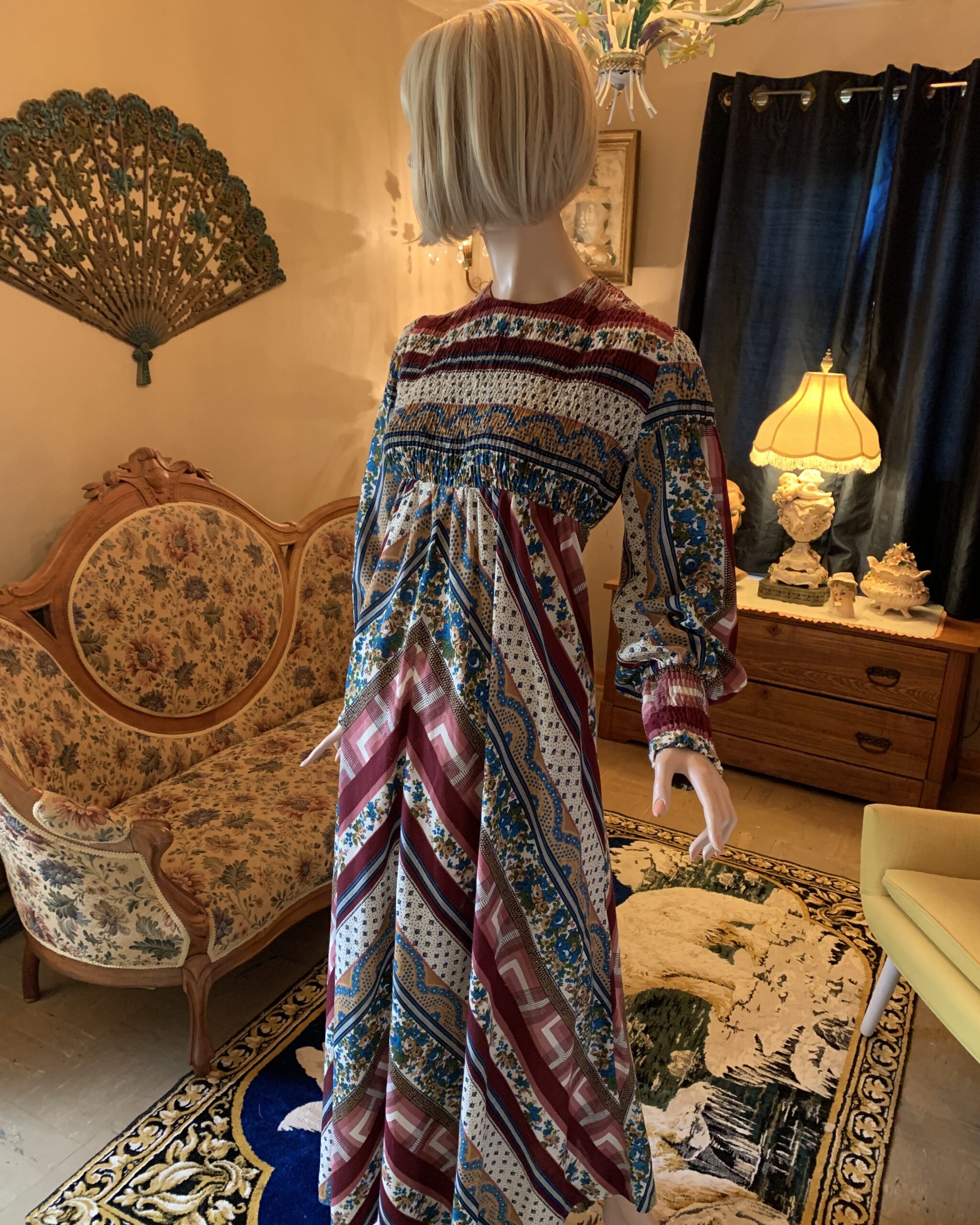 Rag Dolls San Francisco prairie maxi dress with smocked bodice, long sleeves, and mixed floral geometric print in burgundy, blue, and cream.